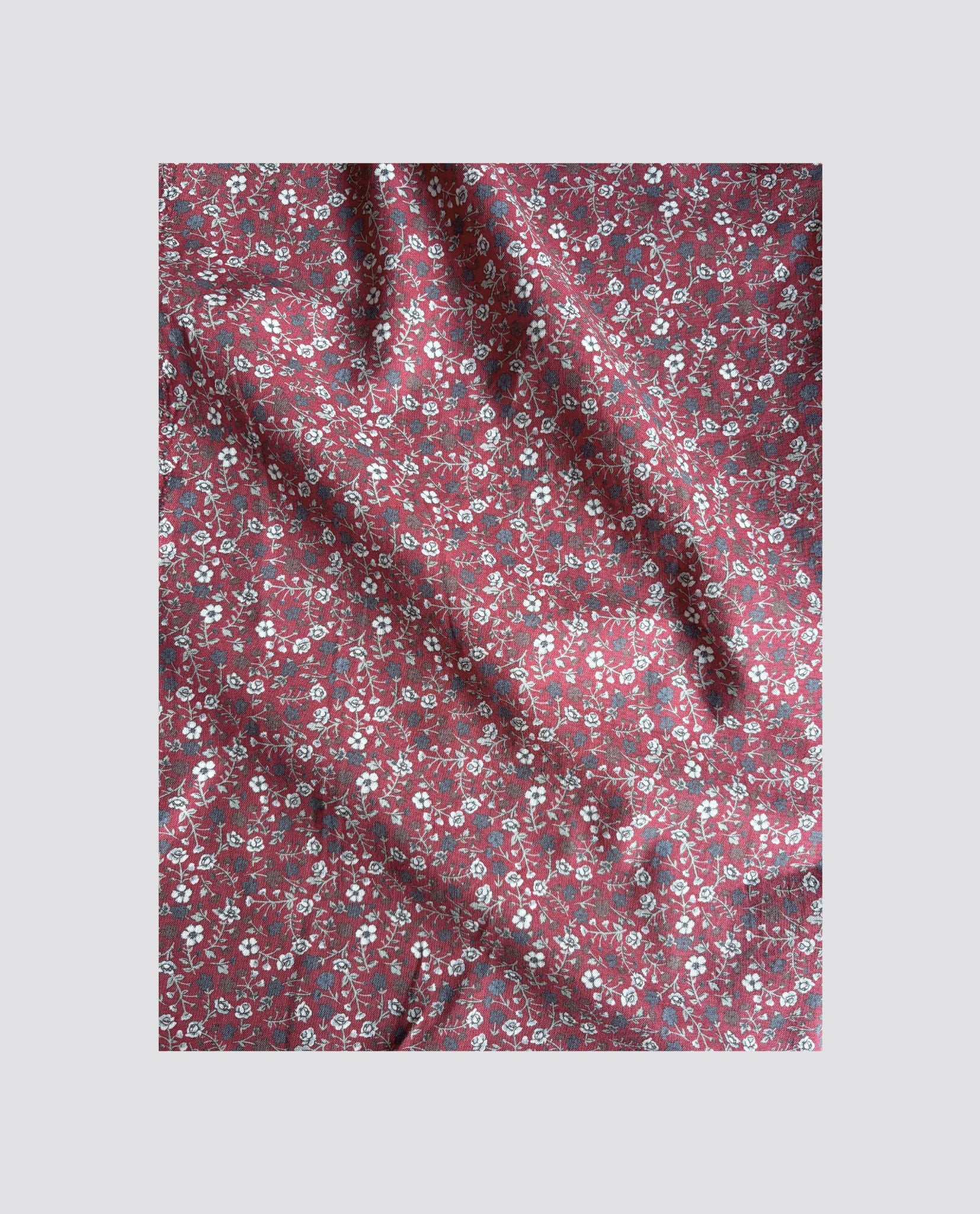 Brown floral organic cotton fabric with a vintage style pattern, designed for sustainable and ethical children’s clothing in natural materials.