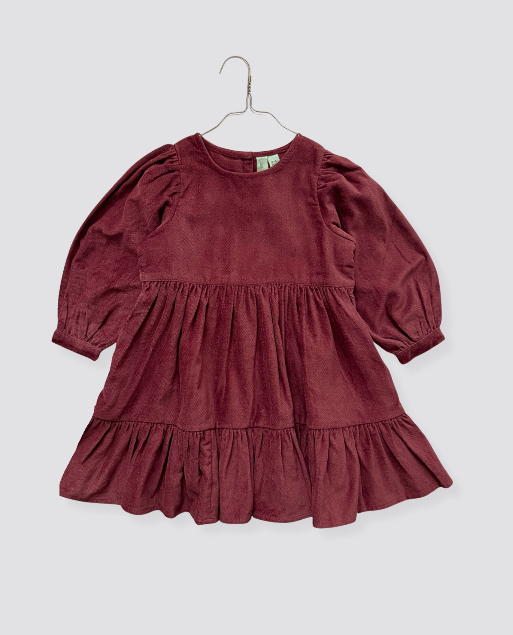 Vintage style girls dress in deep red velvet made from organic cotton, featuring a collarless design and long puffed sleeves, perfect for sustainable kids clothing.