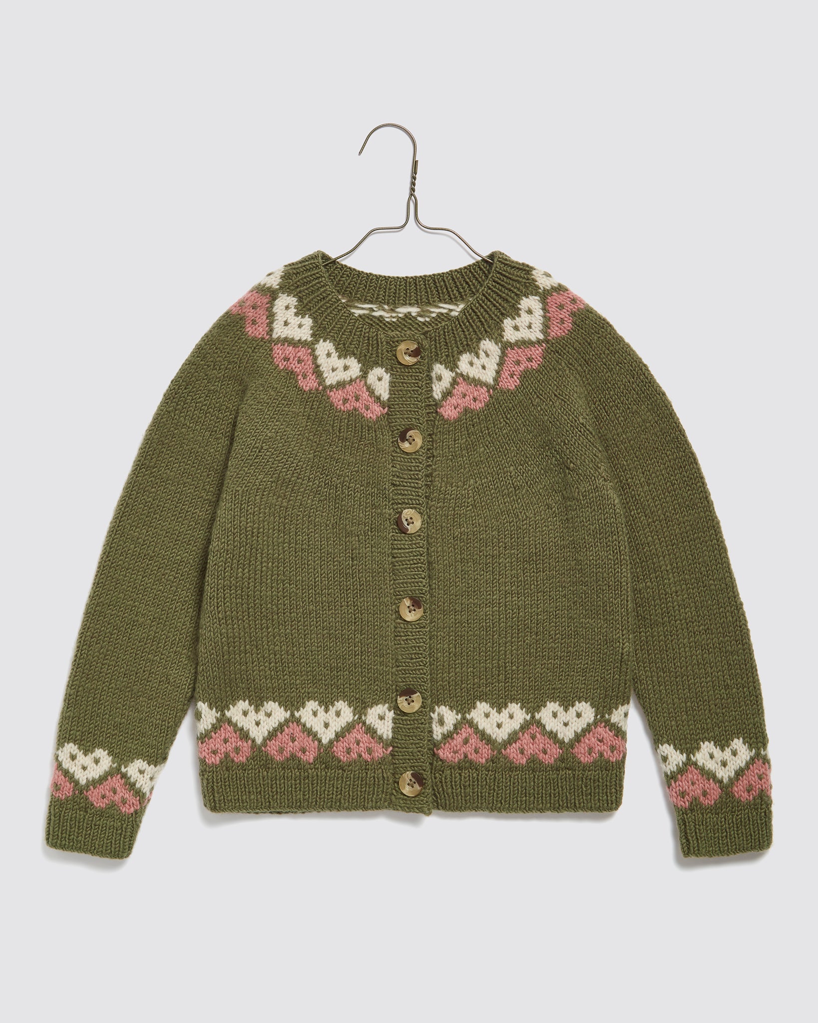 Child’s hand-knitted cardigan in merino wool with multicolor blue heart pattern, vintage-inspired, sustainable and ethically made for a slow, natural childhood style.