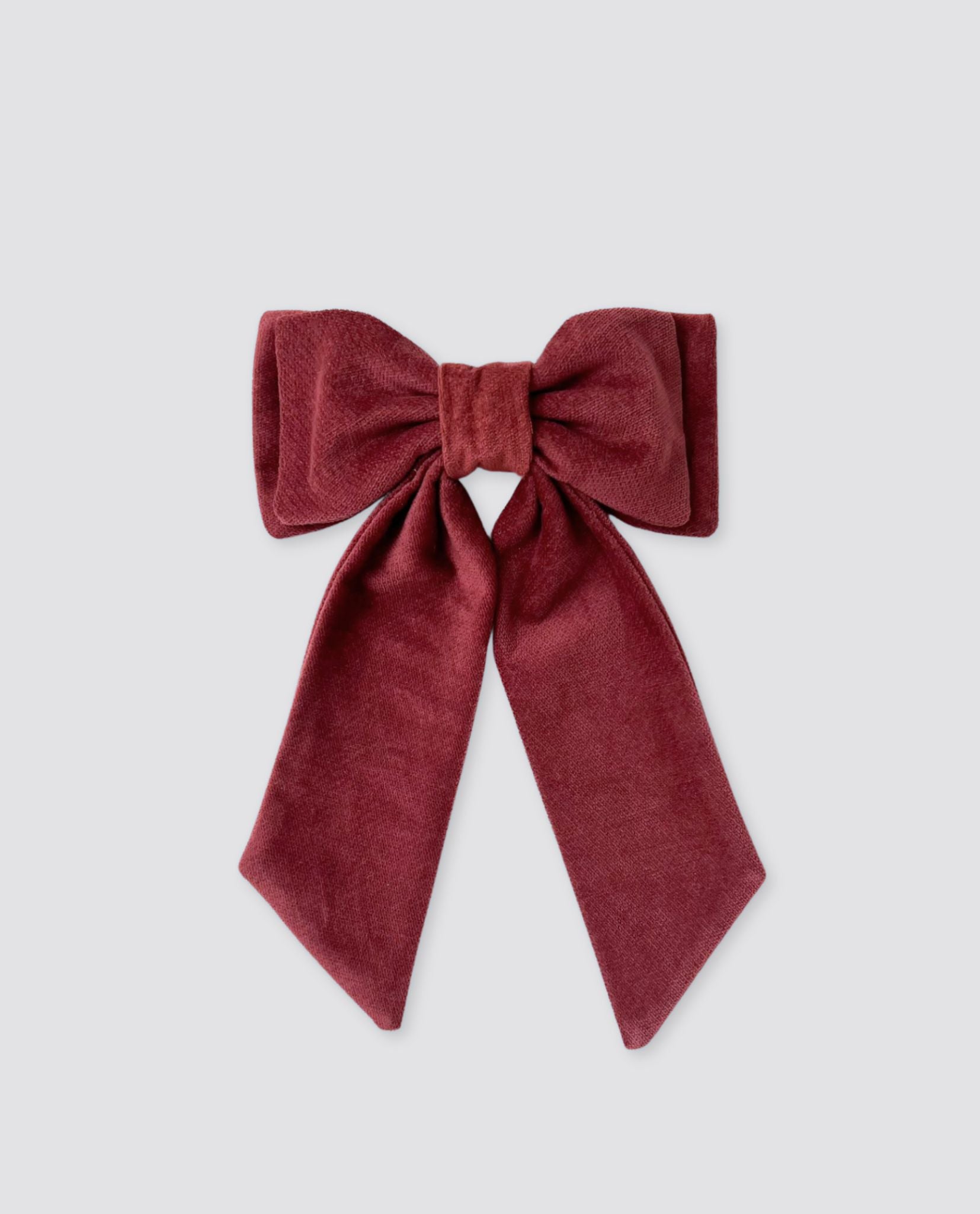 Red velvet bow clip for kids made from soft, sustainable materials in a classic vintage style, perfect for adding a natural, organic touch to children's outfits.
