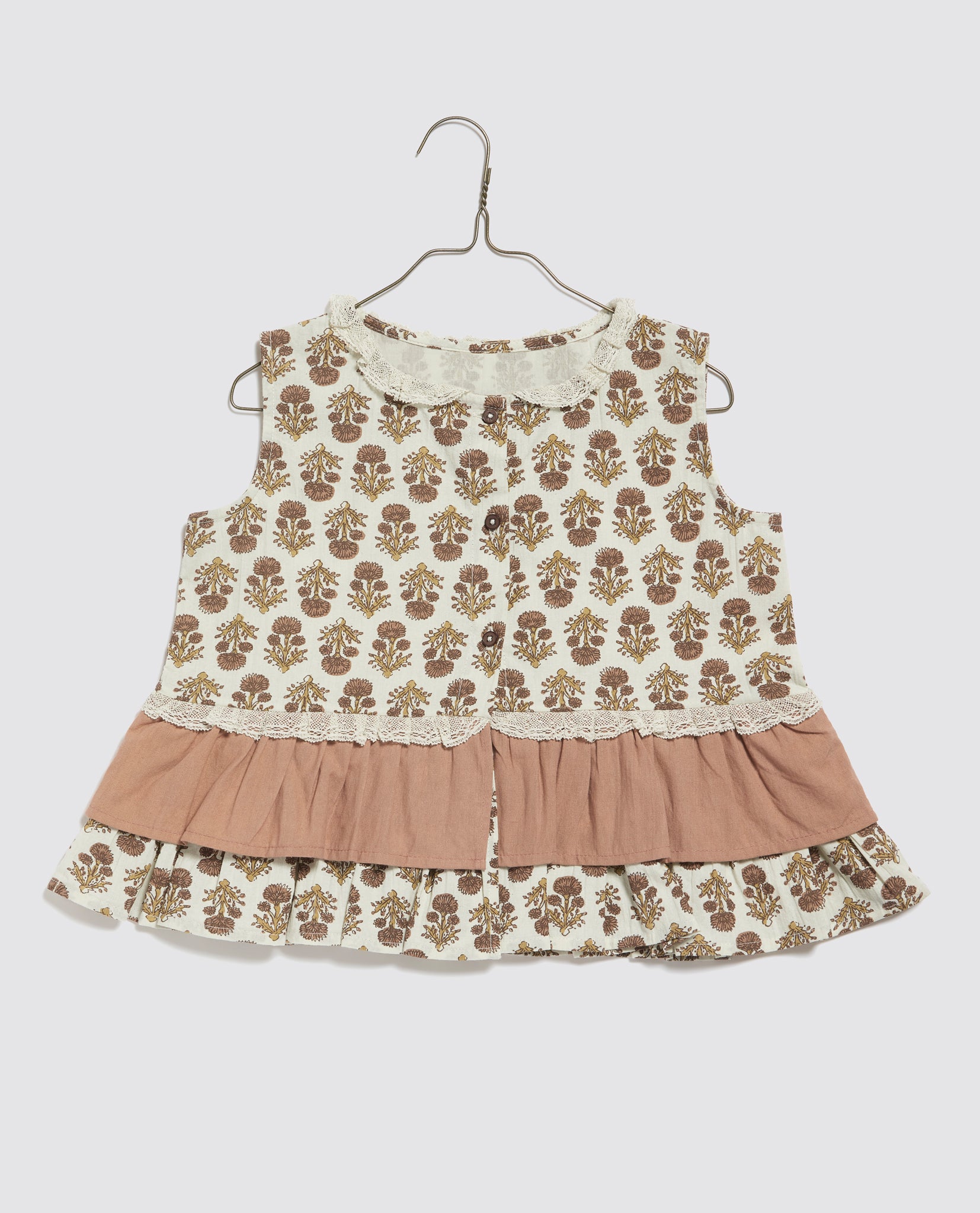 Vintage style girls blouse featuring organic cotton with a delicate floral pattern and soft tea rose ruffle, designed for sustainable and ethical children's clothing.