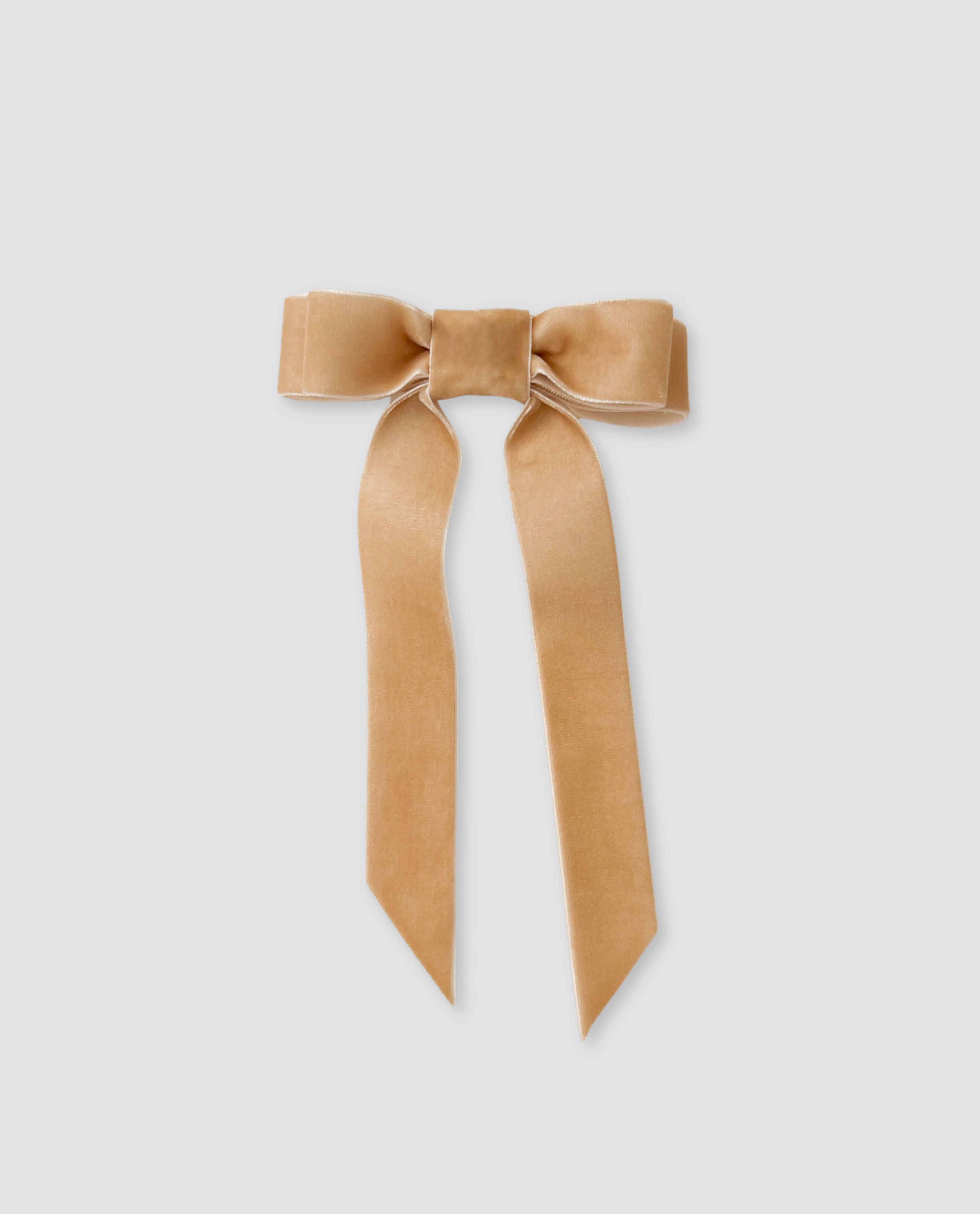 Caramel-colored velvet hair bow with long flowing tails, crafted with natural materials for a vintage-inspired, ethically made children's accessory.