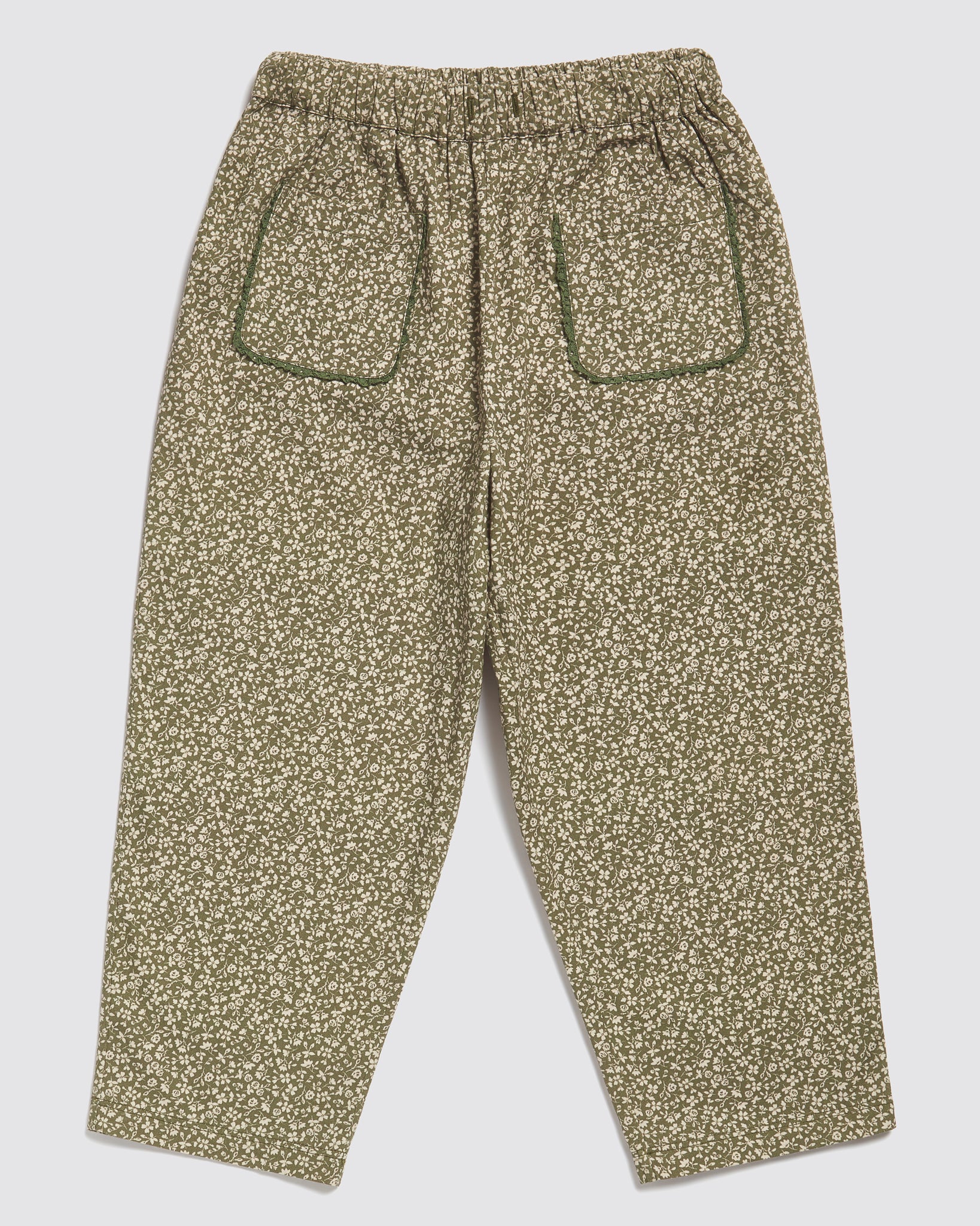 Green floral organic cotton children's trousers with front patch pockets, featuring a vintage-inspired style and ethical, sustainable design for kids.