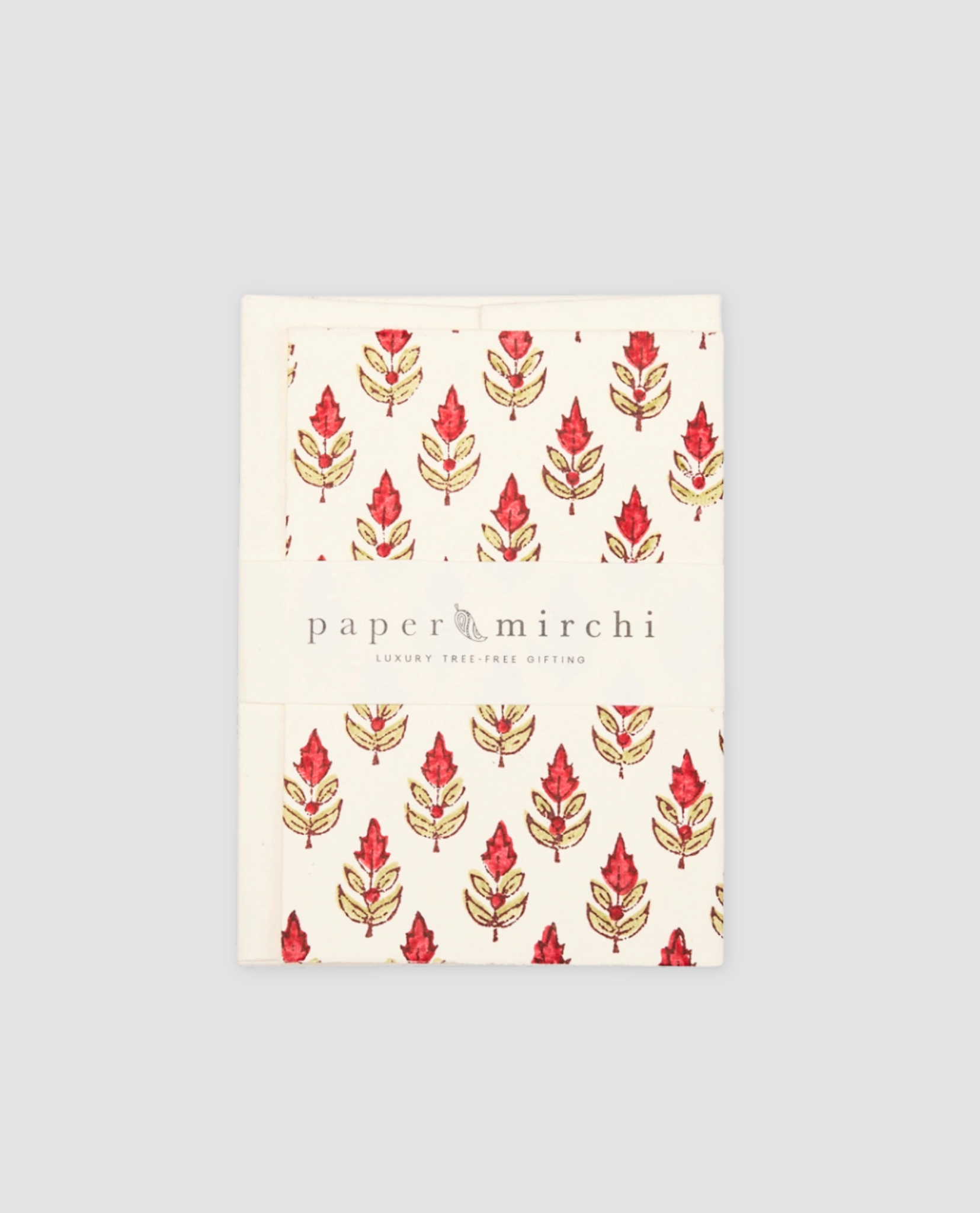 Hand block printed greetings card with a simple red and green floral buti pattern on natural cream paper, reflecting vintage style and sustainable craftsmanship.