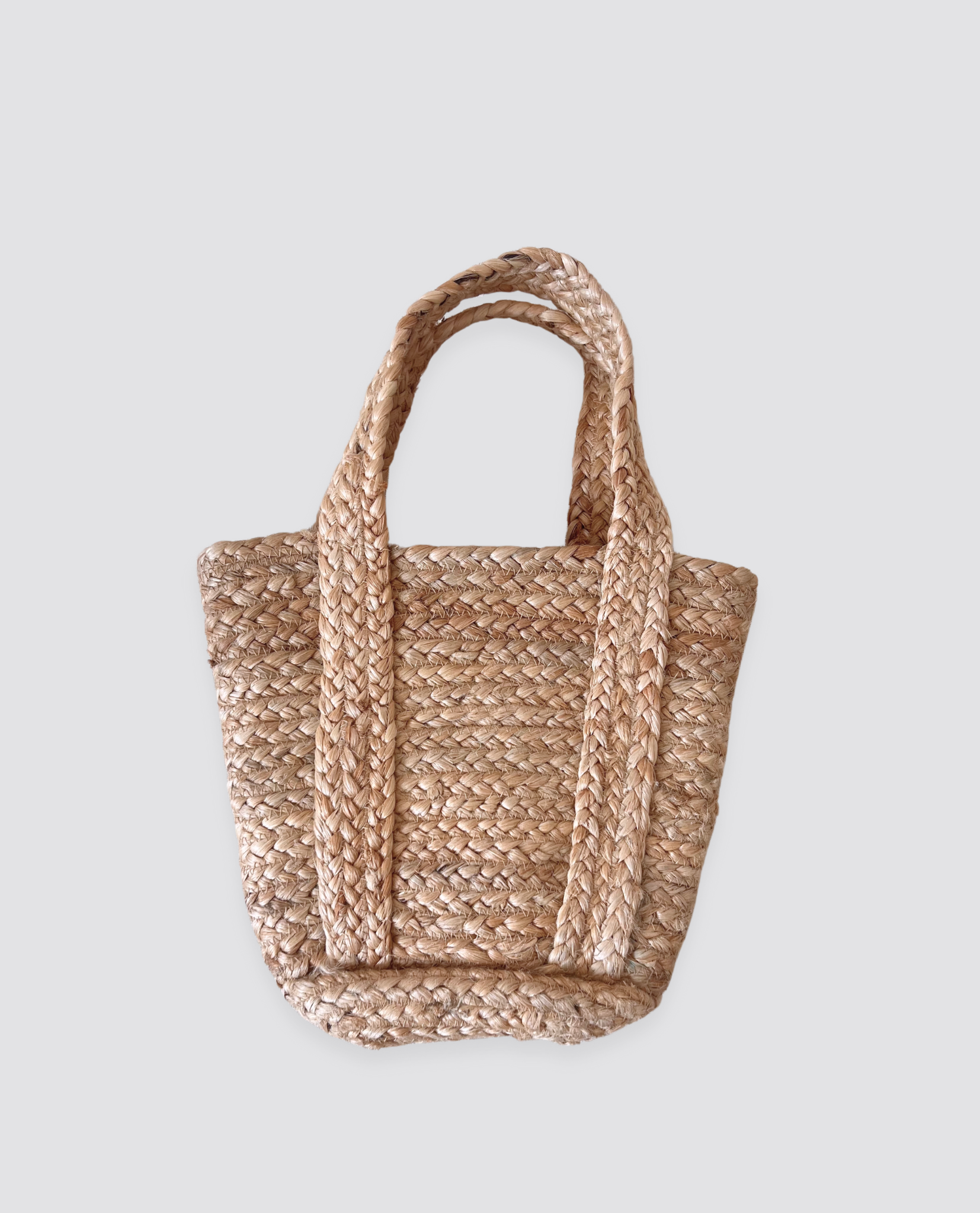 Handwoven natural fiber bag with sturdy handles, featuring a rustic, eco-friendly design perfect for slow, sustainable living and effortless vintage style.