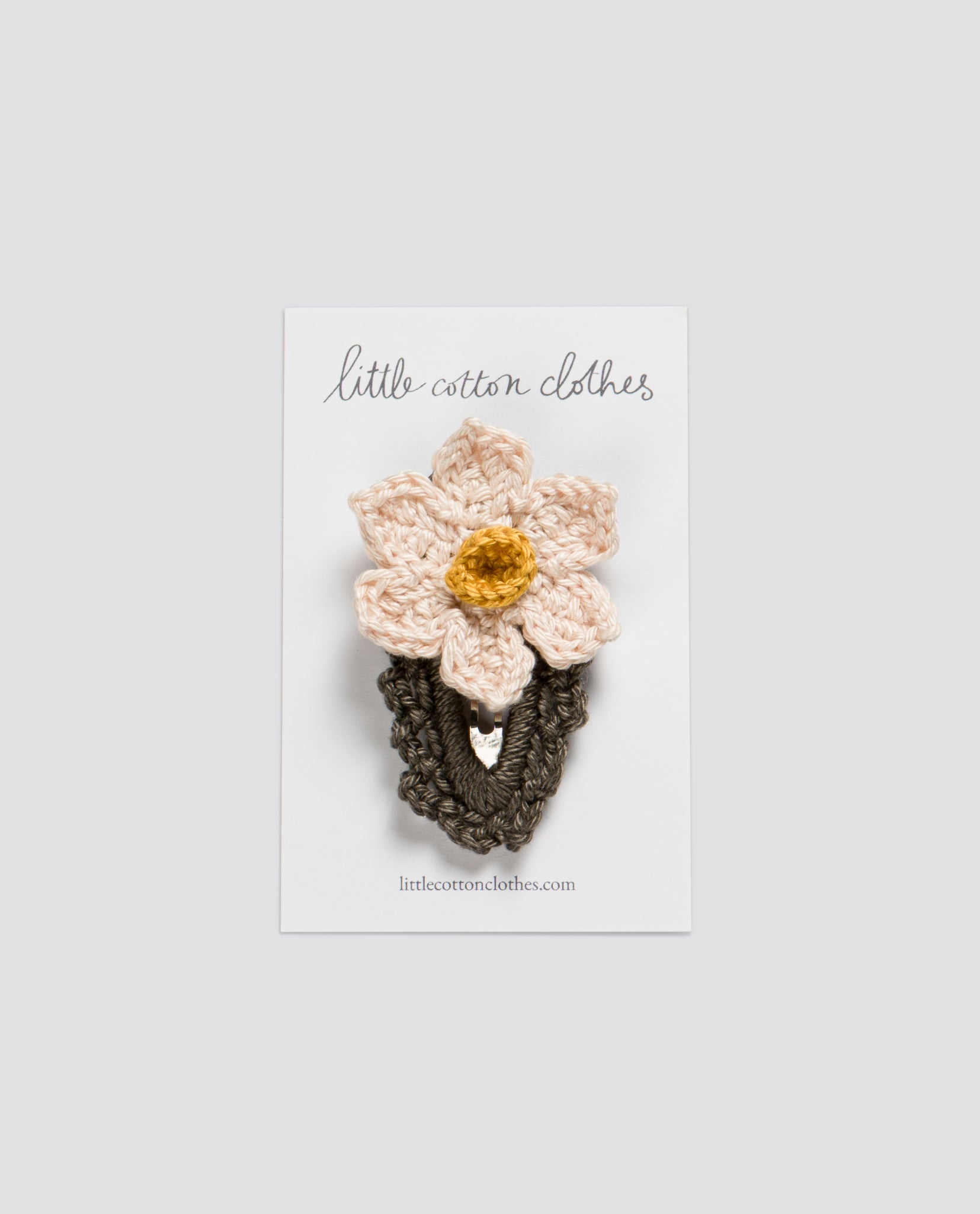 Crochet hair clip featuring a vintage-inspired daffodil design made from natural cotton, perfect for girls and ethically crafted by a sustainable children's clothing brand.