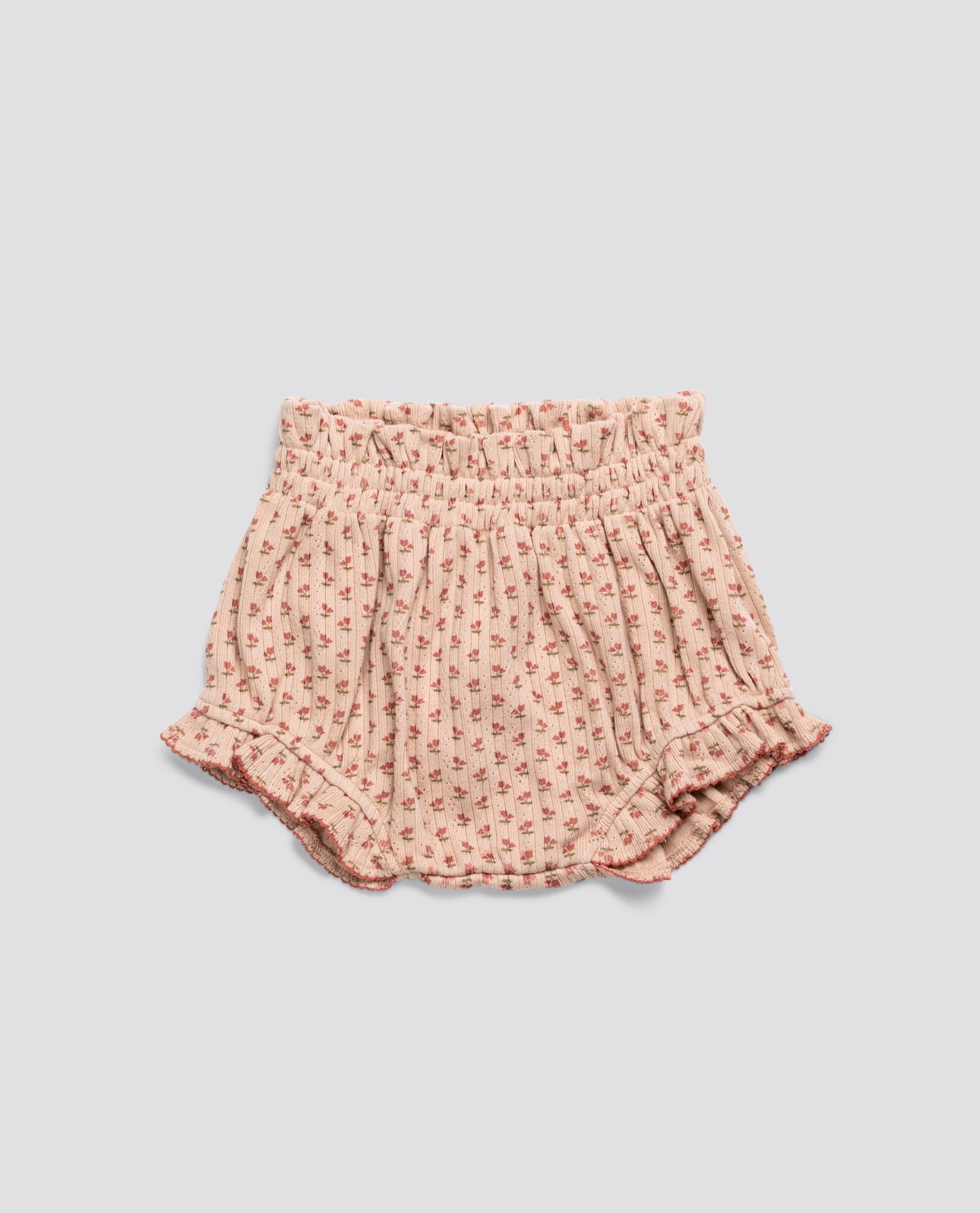 Pink floral organic jersey cotton bloomers for babies and toddlers with vintage-inspired ruffled edges and elasticated waistband, ethically made and sustainable.