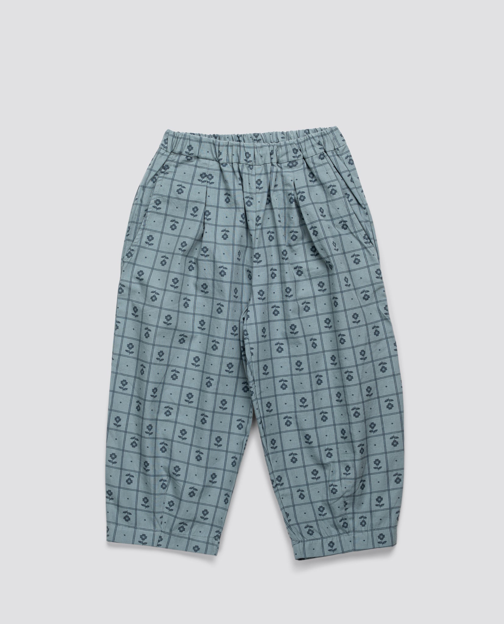 Light blue vintage style children's trousers with a subtle floral grid pattern, made from soft organic cotton for sustainable, ethical kids clothing.