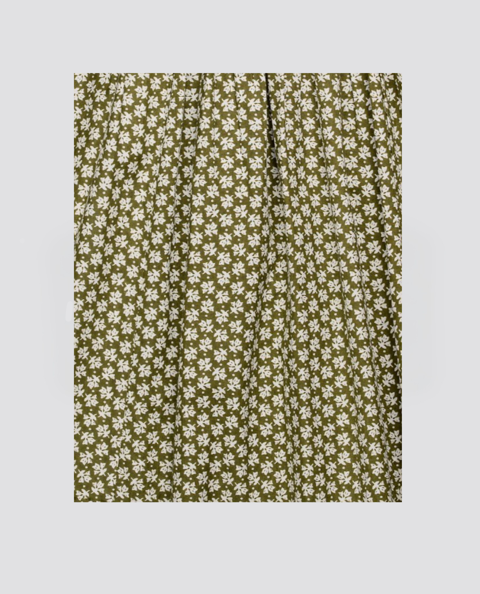 Green organic cotton fabric with small white floral vintage pattern, perfect for making sustainable children's clothing with a natural, ethical touch.