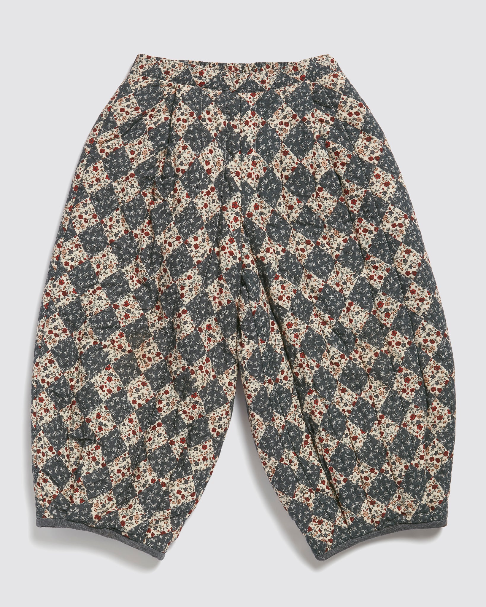 Quilted children's trousers featuring a vintage-inspired harlequin floral pattern in soft, natural cotton, designed with ethical and sustainable values in mind.