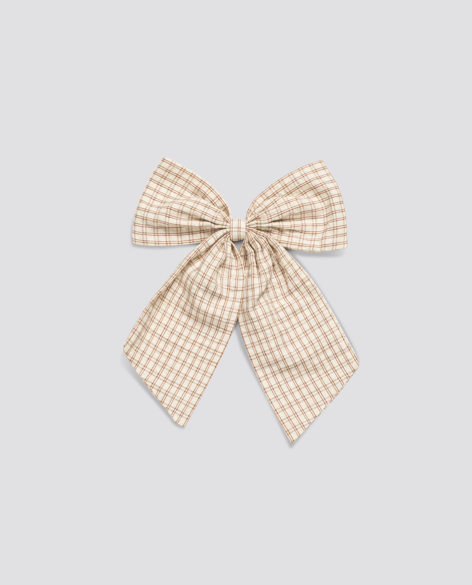 Soft vintage-style bow with elastic, made from natural cotton in a delicate straw check pattern, perfect for ethical children's clothing.