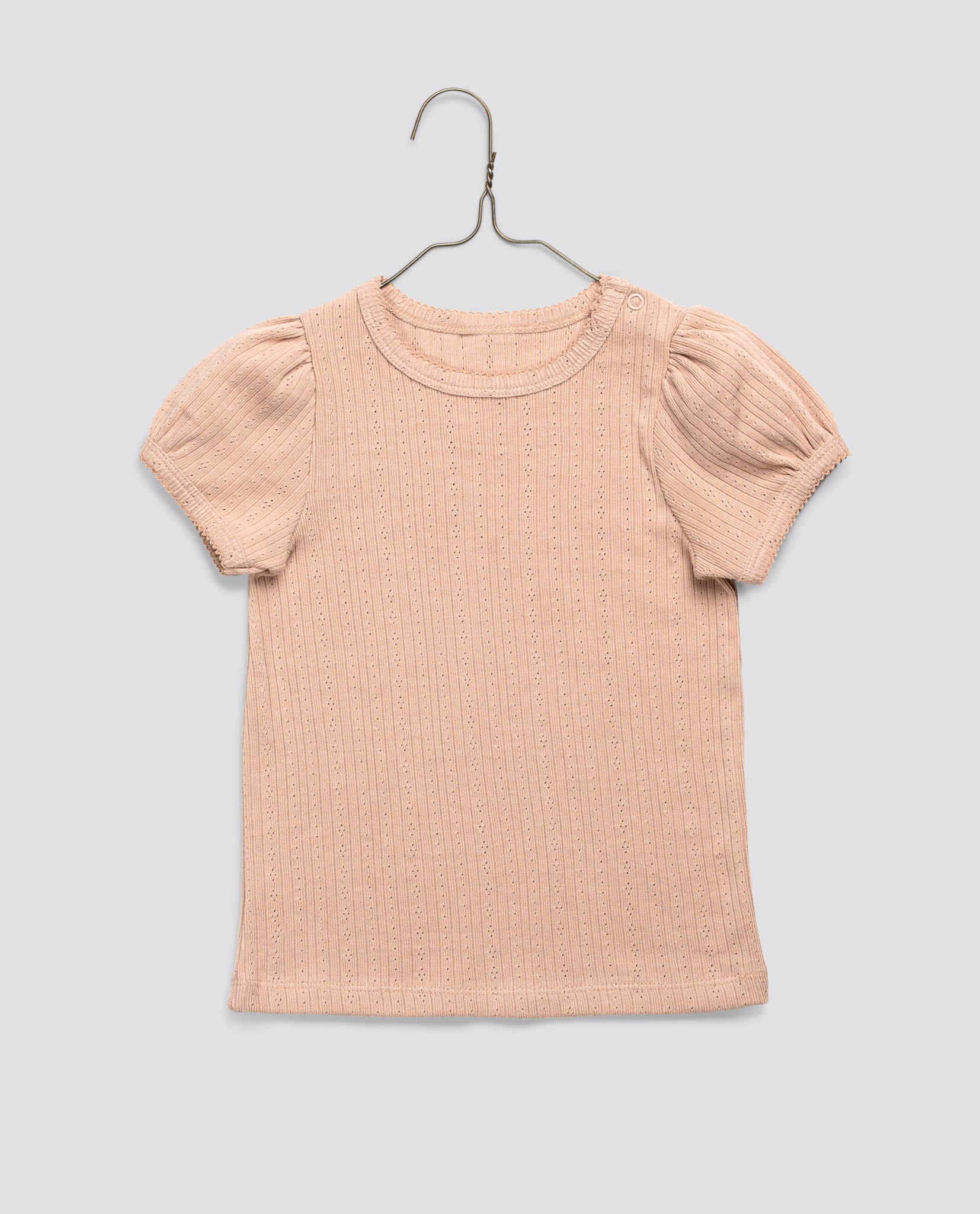 Powder pink organic jersey cotton t-shirt for girls with subtle pointelle pattern and puff sleeves, designed in a vintage style with sustainable, ethical craftsmanship.