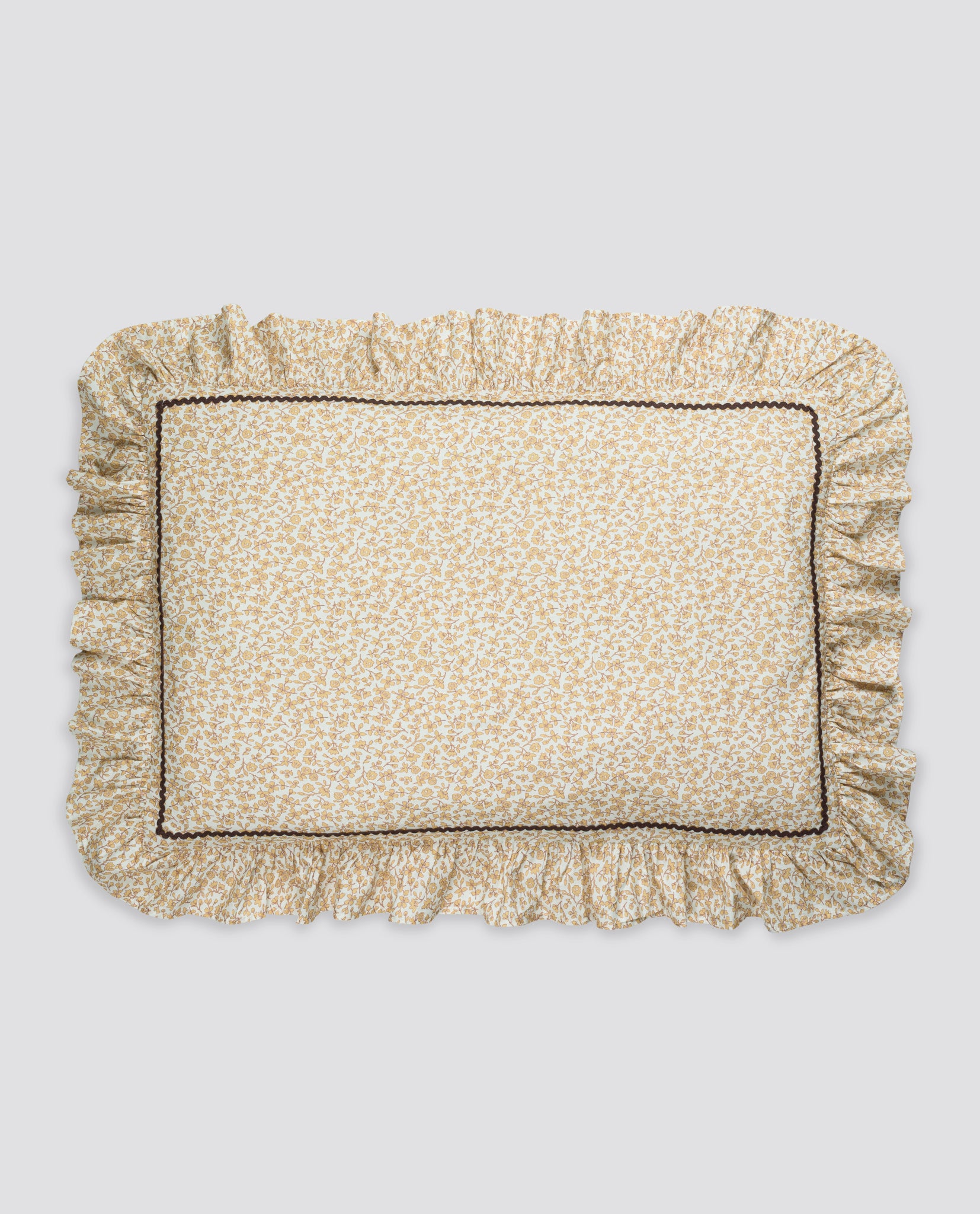 Soft pillowcase with delicate vintage-inspired floral print, featuring ruffled edges and subtle stitching, made from sustainable organic cotton for a natural, gentle touch.