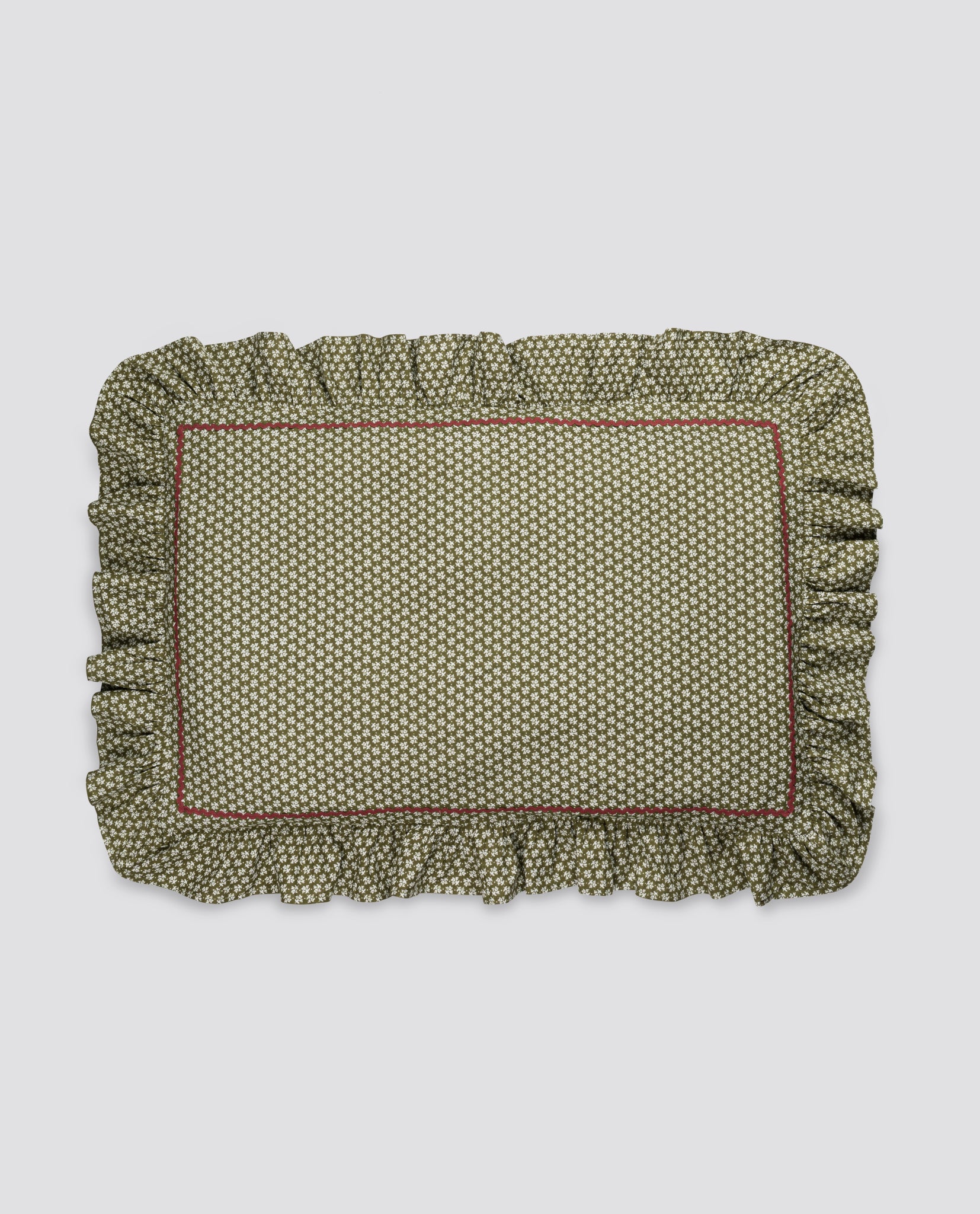 Soft organic cotton pillowcase with delicate vintage floral pattern and ruffled edges, crafted ethically for a natural, sustainable childhood environment.