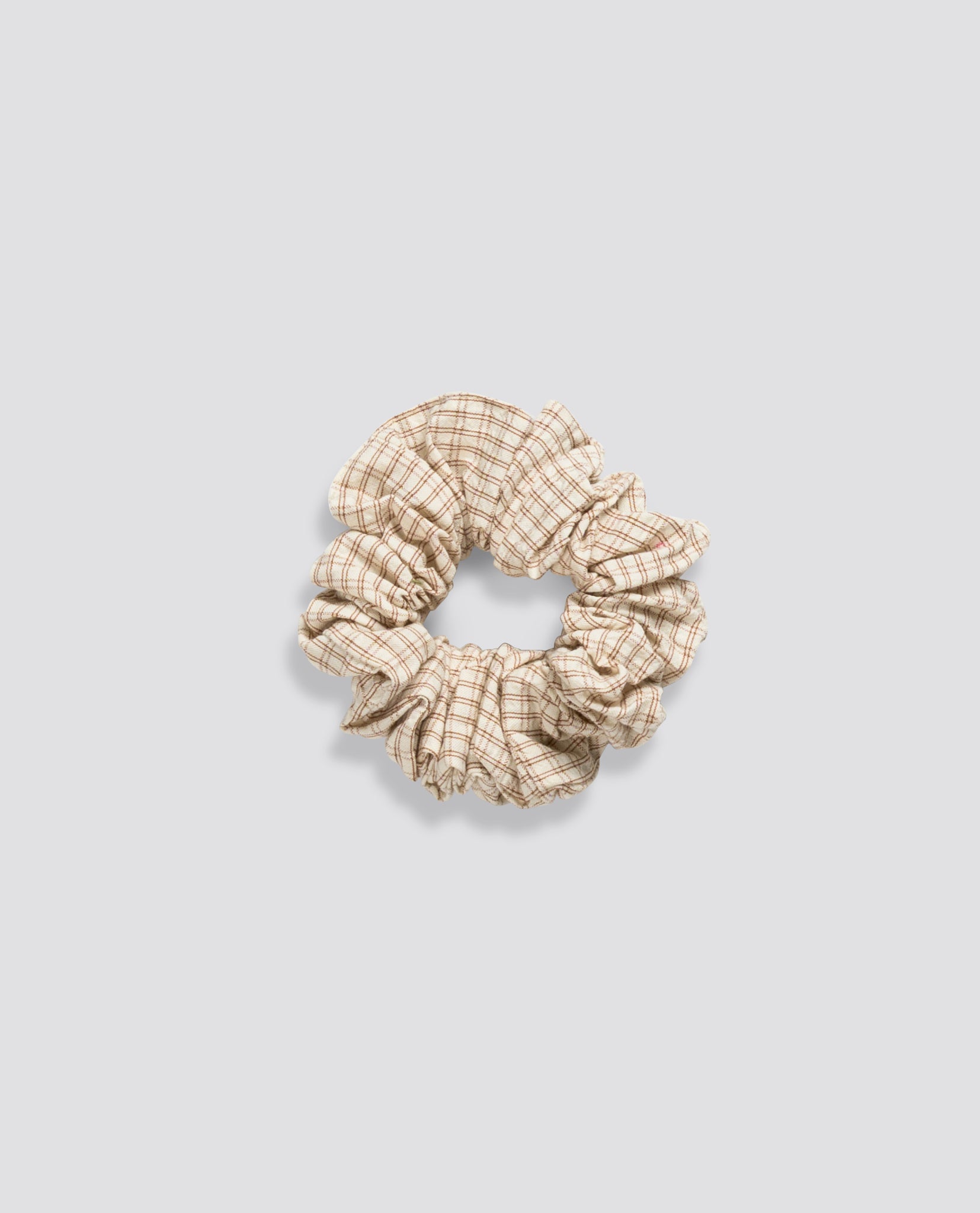 Natural cotton scrunchie with soft vintage-inspired check pattern, ethically made for a sustainable and timeless look in children's accessories.