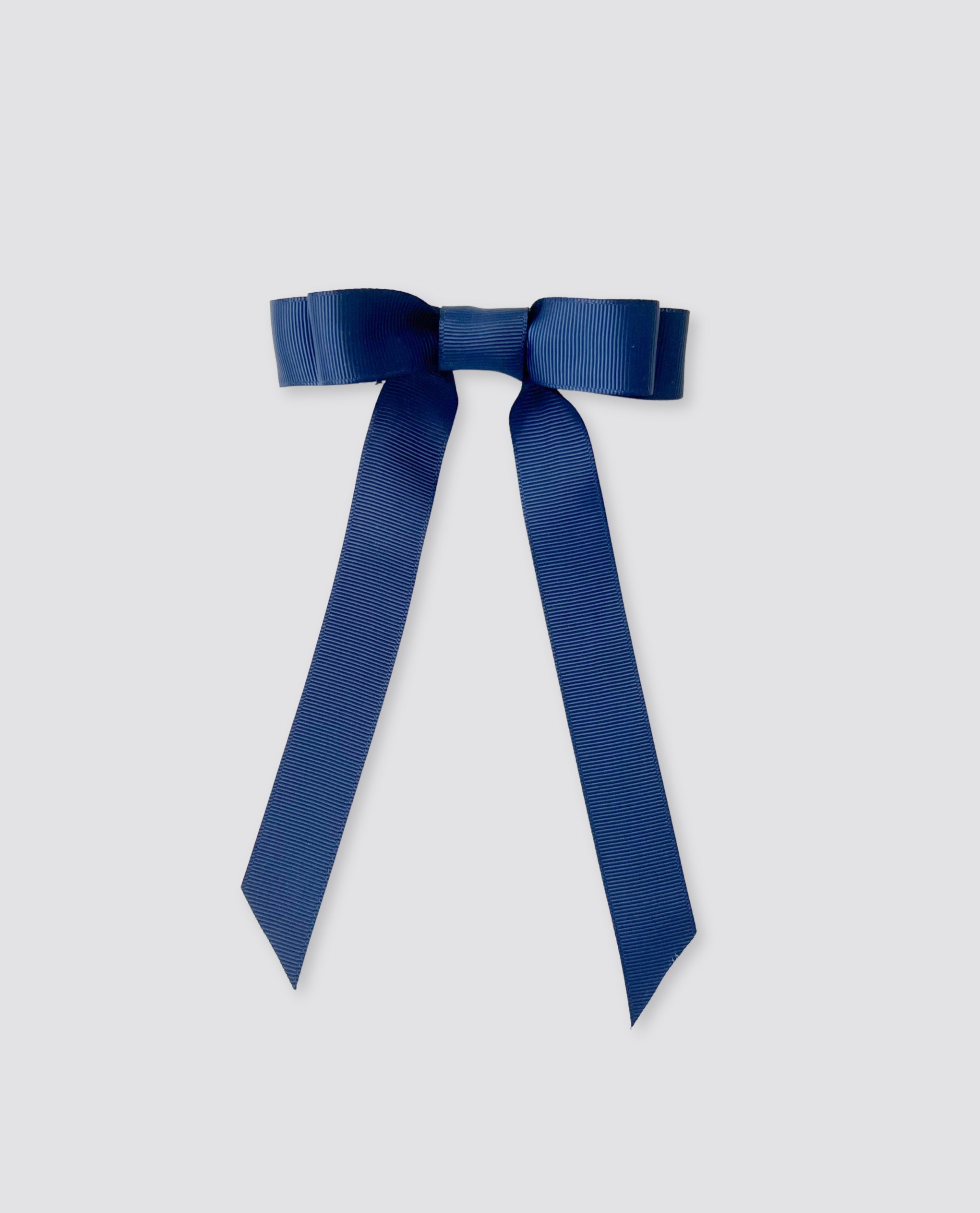 School blue grosgrain hair bow with long tails, featuring a vintage-inspired design perfect for adding a classic touch to children's outfits made from natural materials.