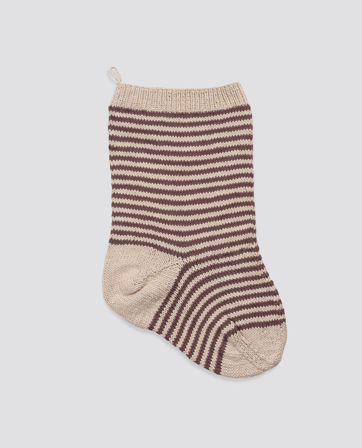 Hand-knitted stocking in natural materials featuring a vintage-inspired pattern in plum and beige, designed with care for an organic, sustainable holiday touch.