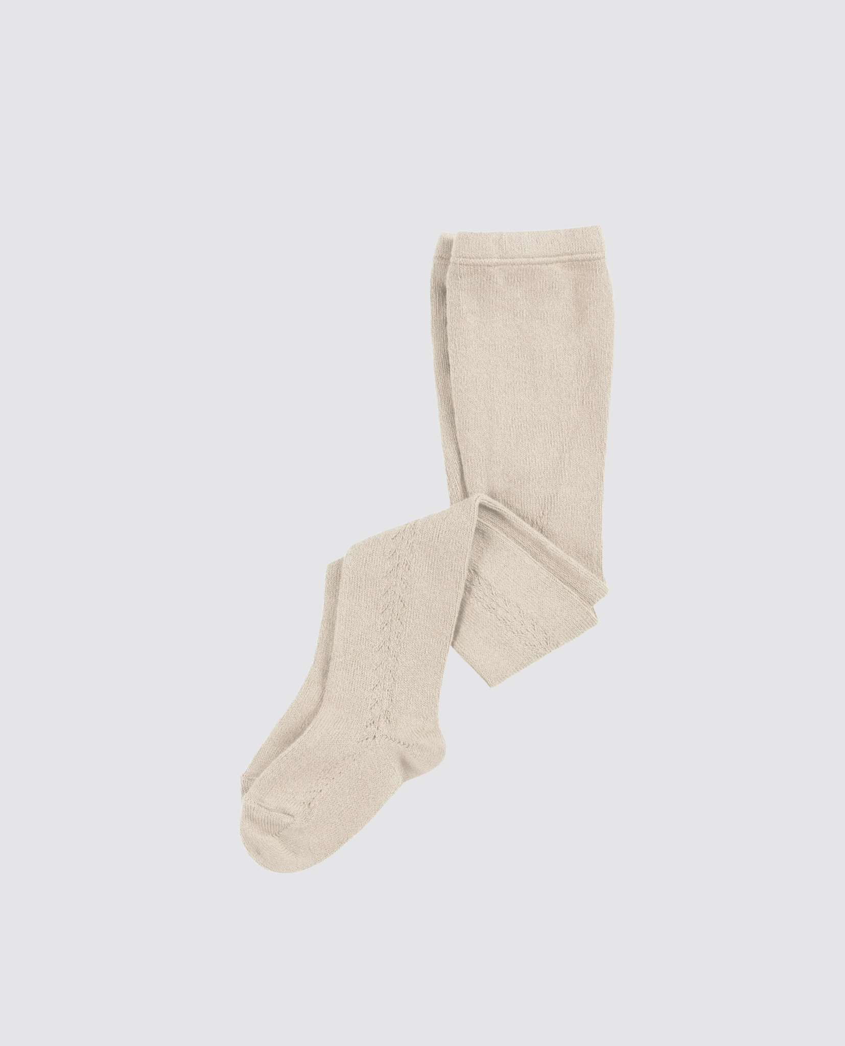 Beige openwork tights for kids made from a soft cotton blend, featuring a vintage-inspired design that is sustainable and ethically crafted for comfort and style.