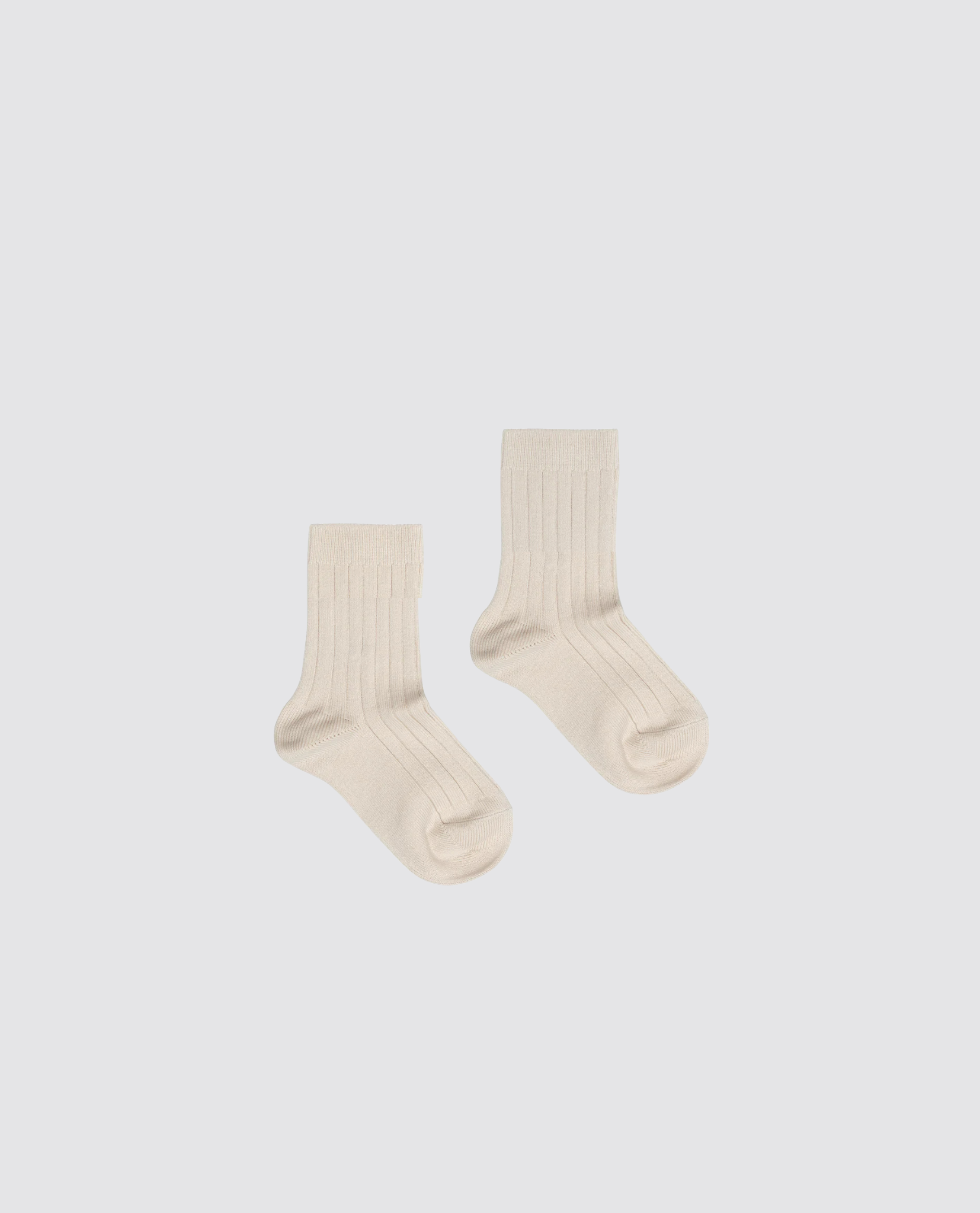 Pair of ribbed ankle socks for kids in a beige cotton blend, featuring a vintage-inspired, natural and sustainable design perfect for ethical children's clothing.
