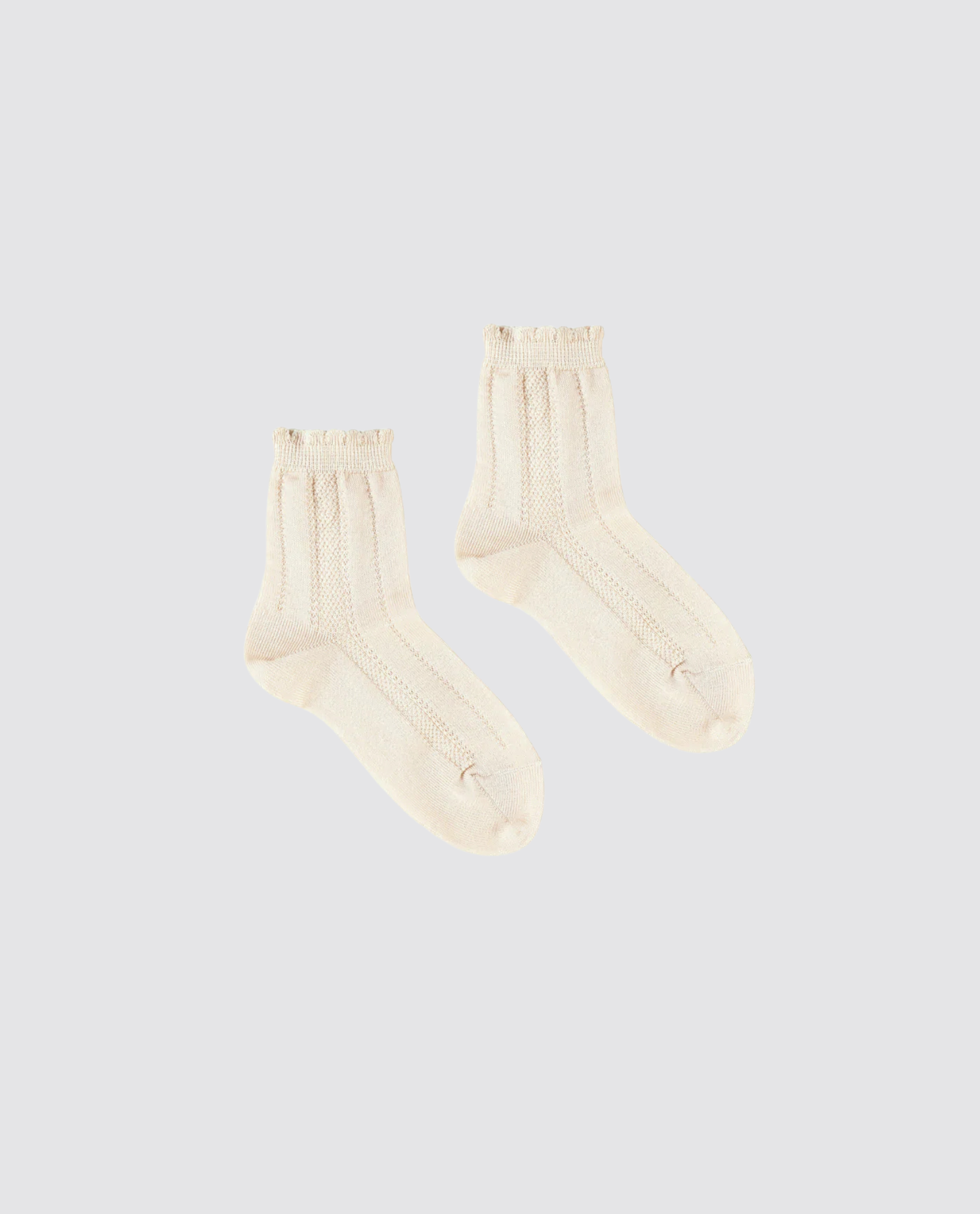 Cream-colored ankle socks for kids made from a soft cotton blend, featuring a delicate vintage-inspired lace frill for a charming traditional look.