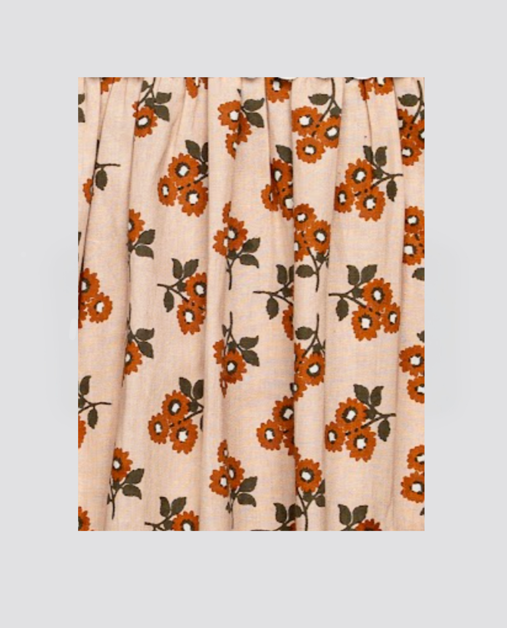 Organic cotton fabric with vintage-style marigold floral print in warm orange and green on a natural background, perfect for sustainable children’s clothing.