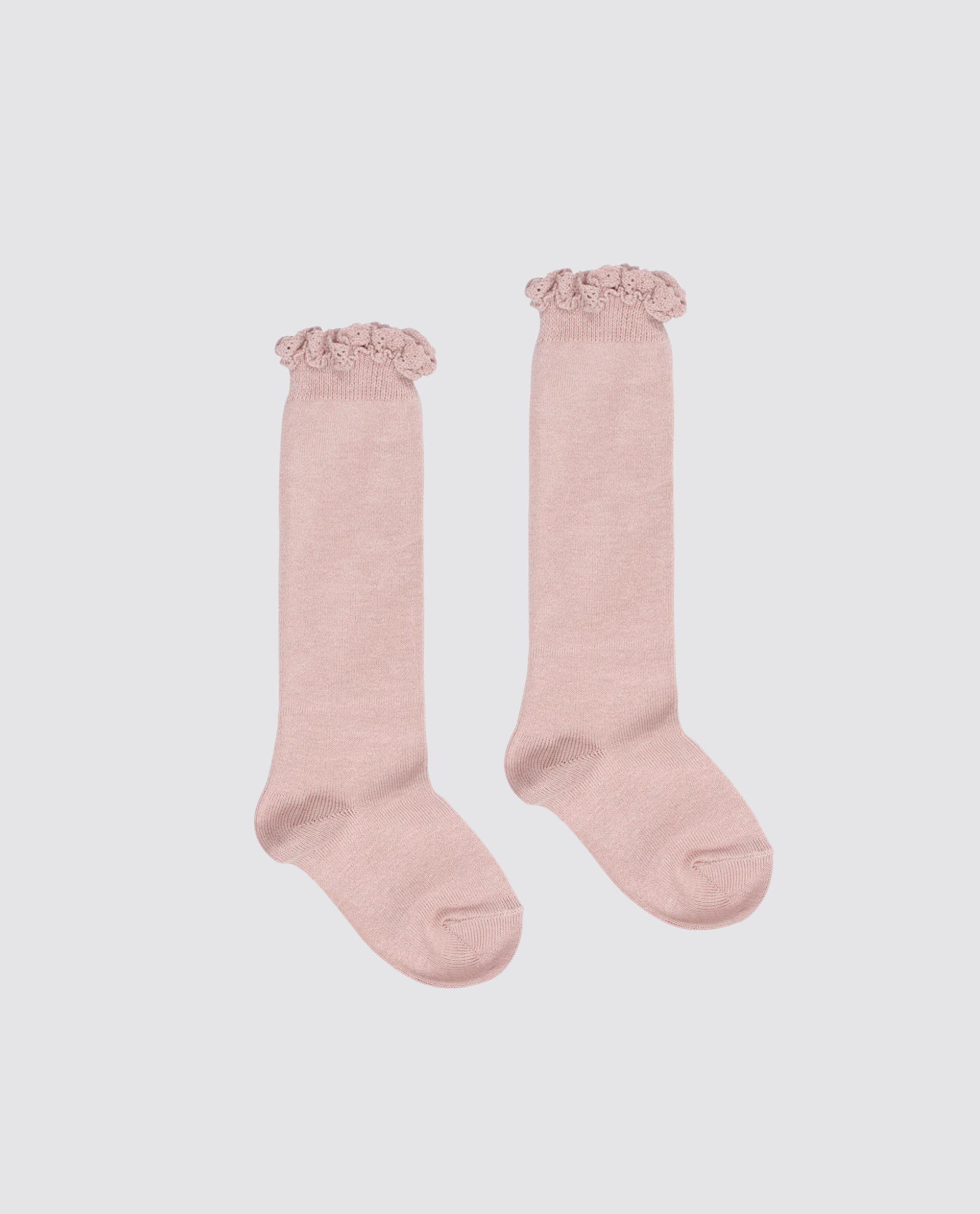 Pair of pink knee high socks for kids made from soft cotton blend with delicate lace frill detailing, designed in vintage style for sustainable children’s clothing.
