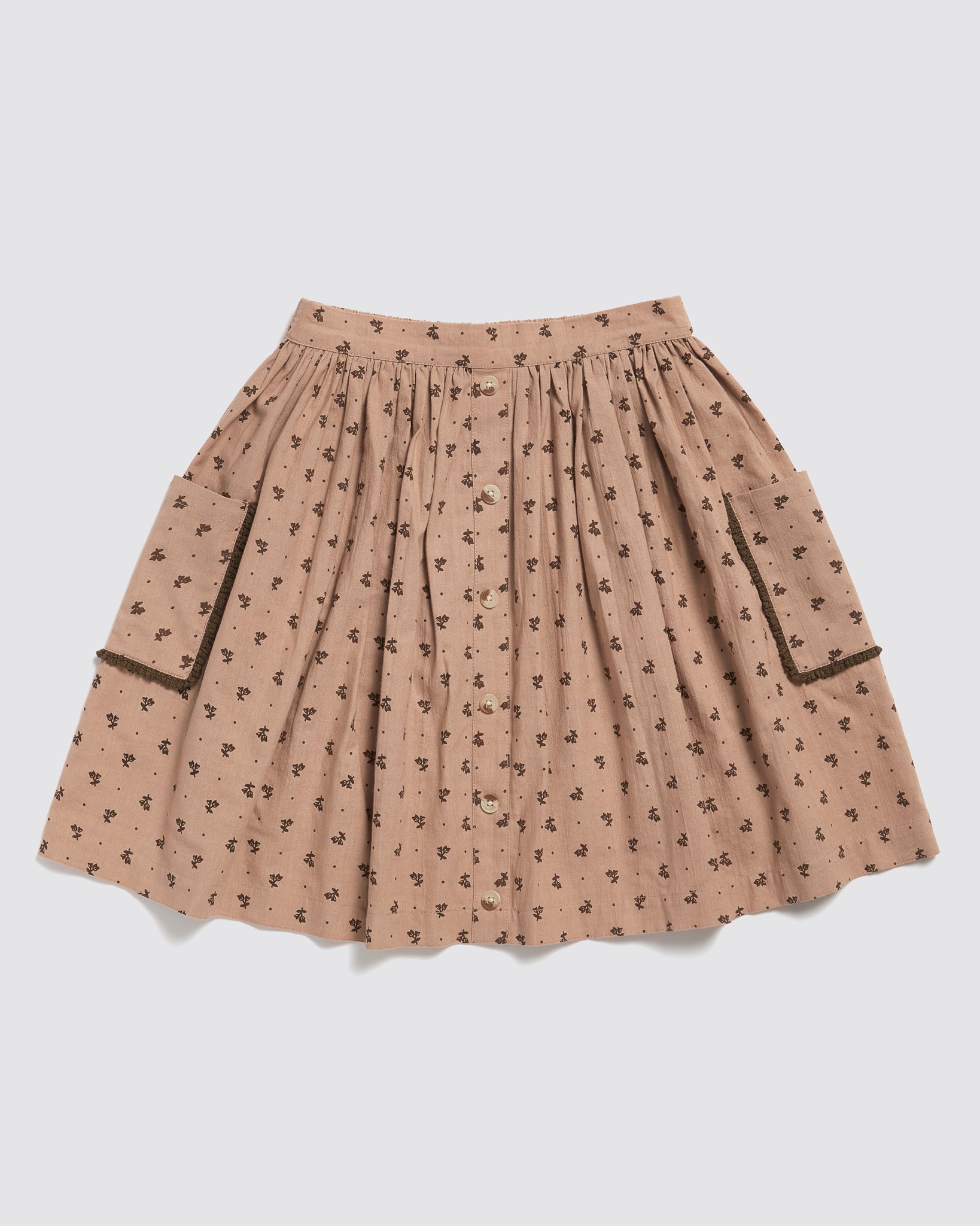 Pink floral vintage-style girls skirt made from organic cotton with button front and side pockets, designed for sustainable and ethical children's clothing.