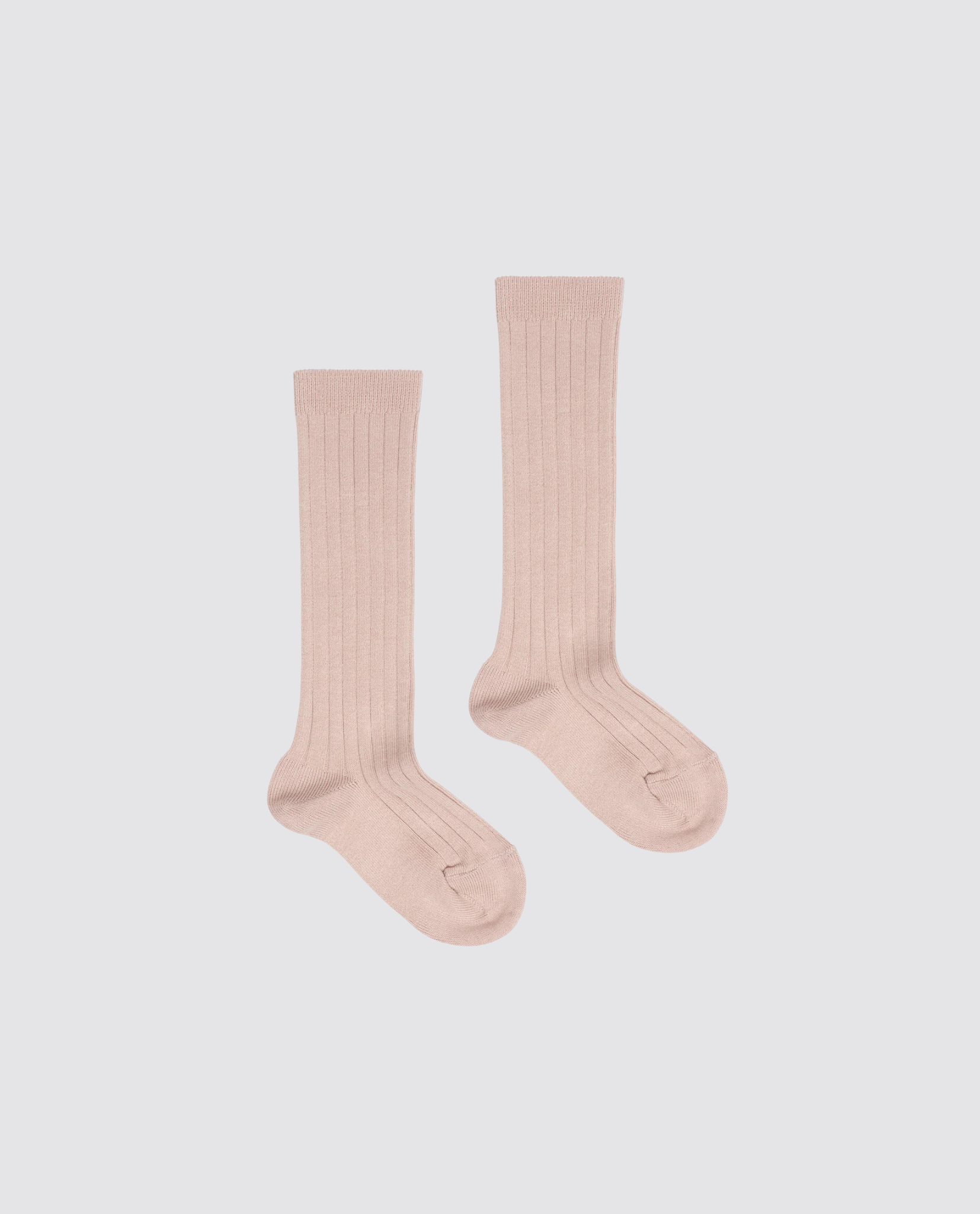 Pair of ribbed knee-high socks for kids in a soft beige cotton blend, designed with a vintage style and made from natural, sustainable materials.