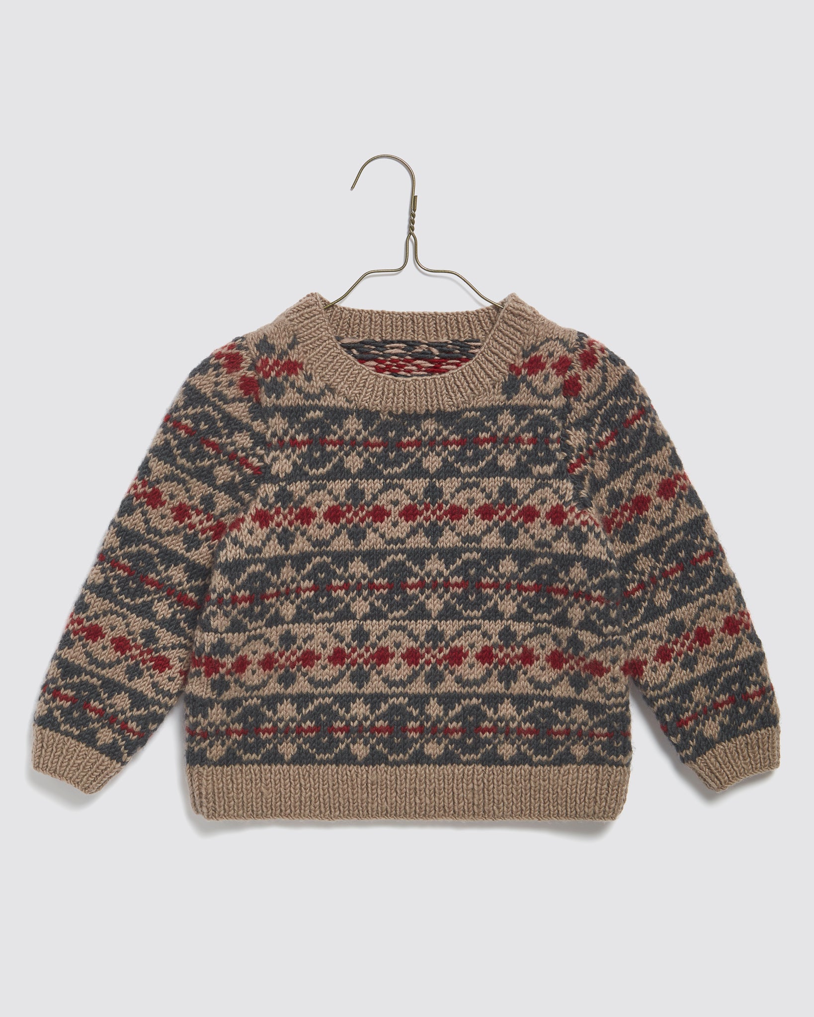 Multicolor hand-knitted children’s jumper made from soft merino wool, featuring a vintage inspired Fairisle pattern, crafted with natural and sustainable materials for a slow, ethical brand.