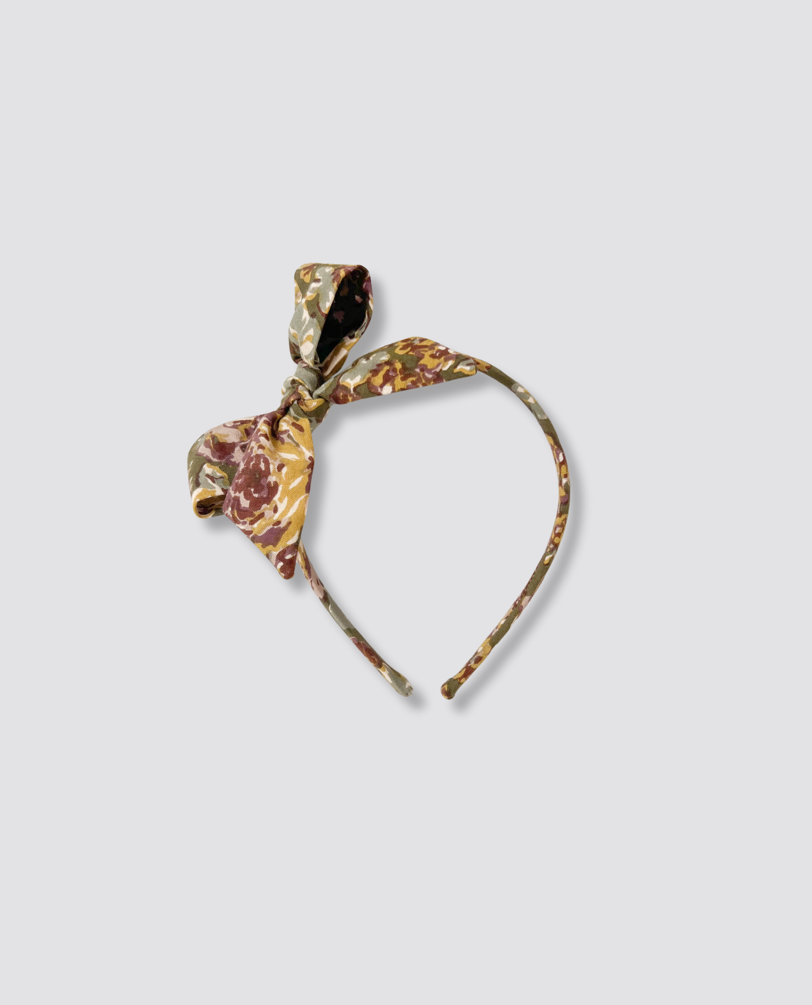 Vintage style floral fabric alice band with a retro knot detail, designed for children and made from natural, organic materials in a small batch, ethical process.