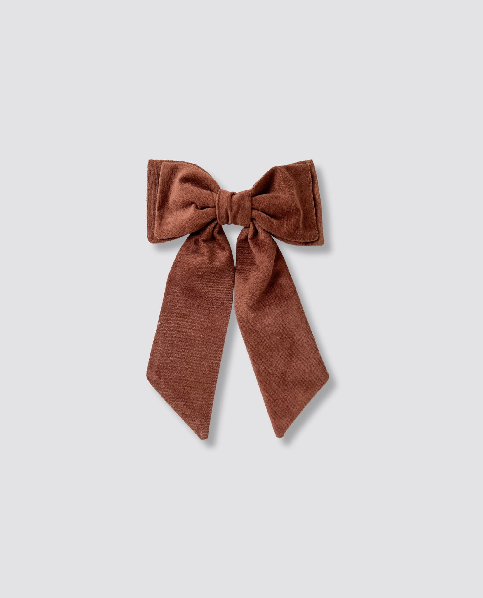 Nutmeg velvet bow clip in a vintage-inspired style, crafted with natural materials for children and adults, reflecting ethical and sustainable design values.