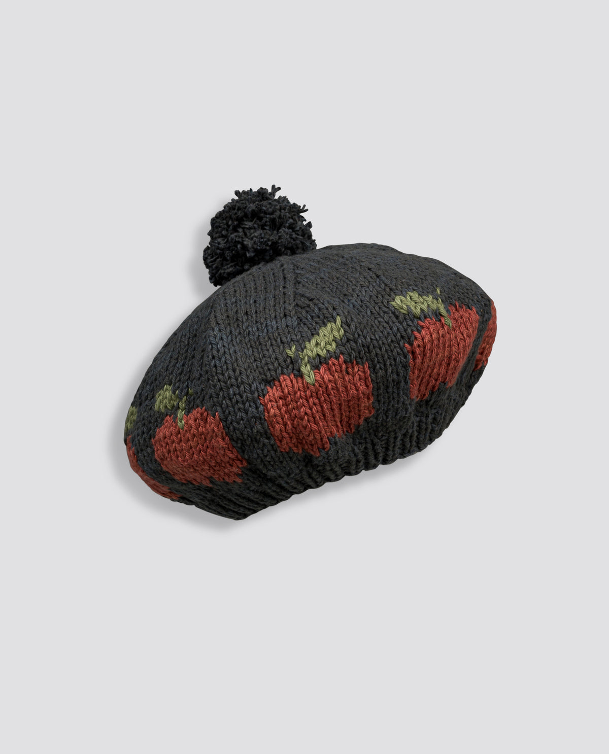 Hand-knitted beret for children featuring a vintage-inspired apple pattern and soft pompom, crafted with care from natural materials.