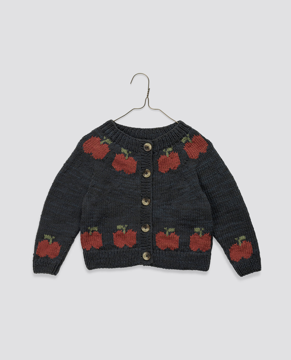 Navy and red hand-knitted cardigan with apple pattern in soft cotton, featuring vintage style and sustainable, ethically made design for children.
