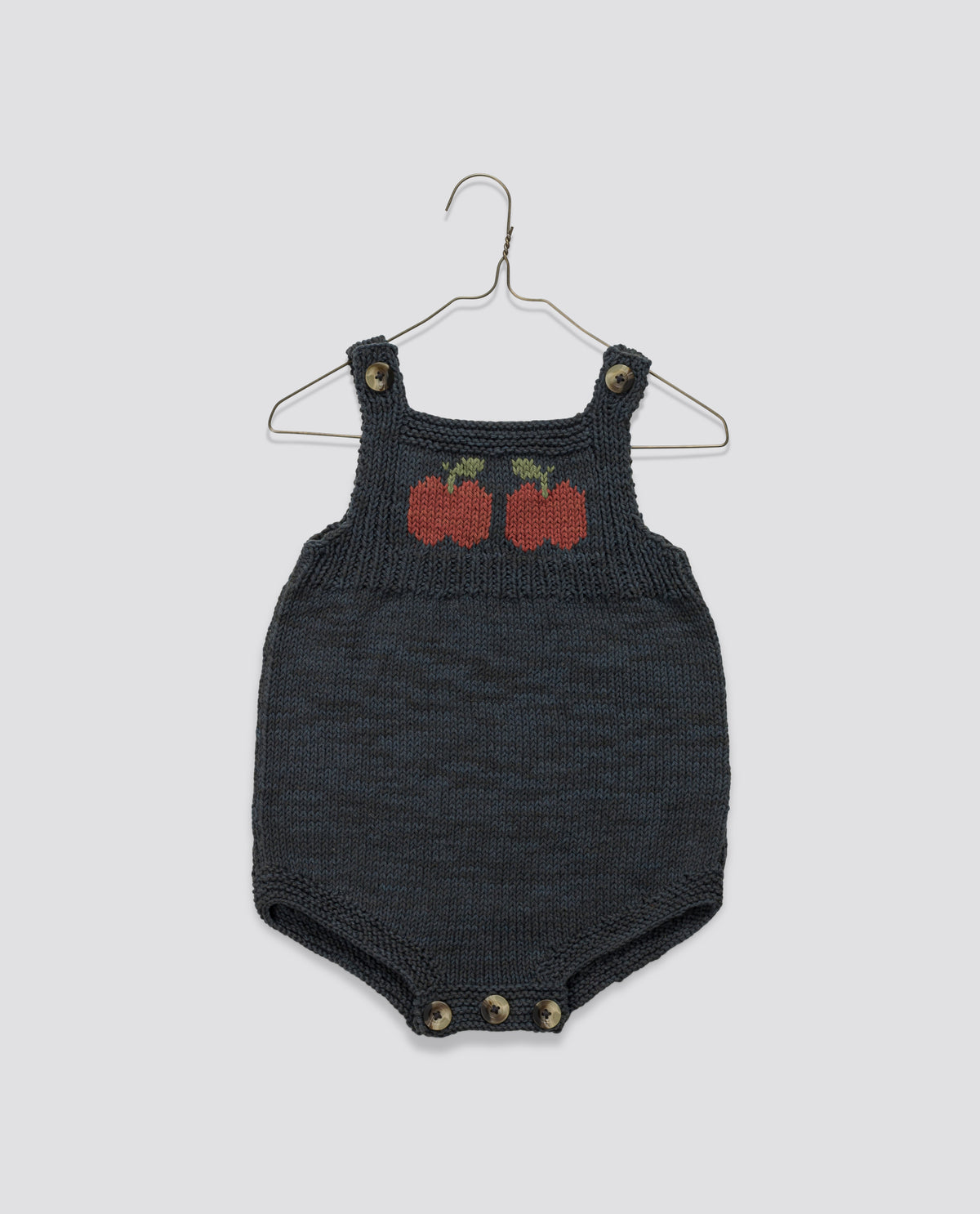 Vintage-inspired hand knitted navy romper with charming apple design, ethically made for sustainable and classic children's clothing.