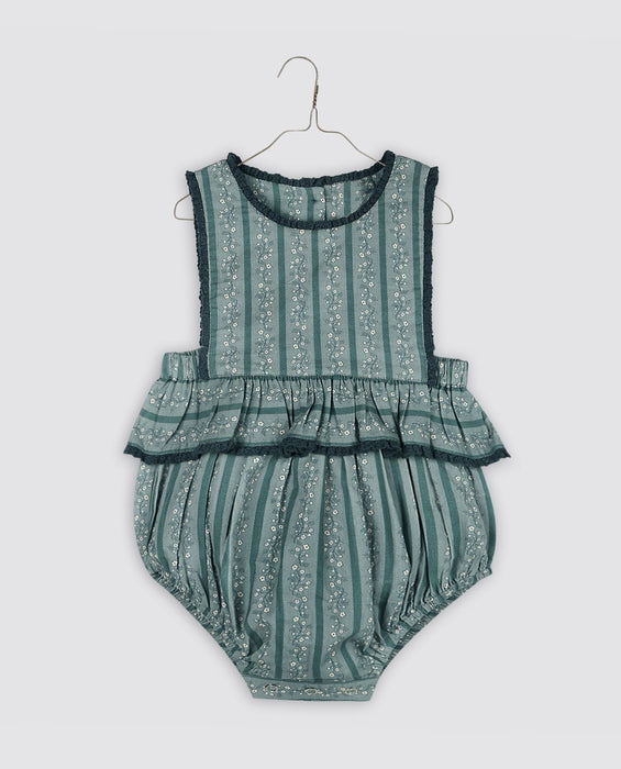 Vintage inspired, teal and Blue floral romper, with frill at the waist finished with gathered trim. Buttons to the back and elastic to the legs.