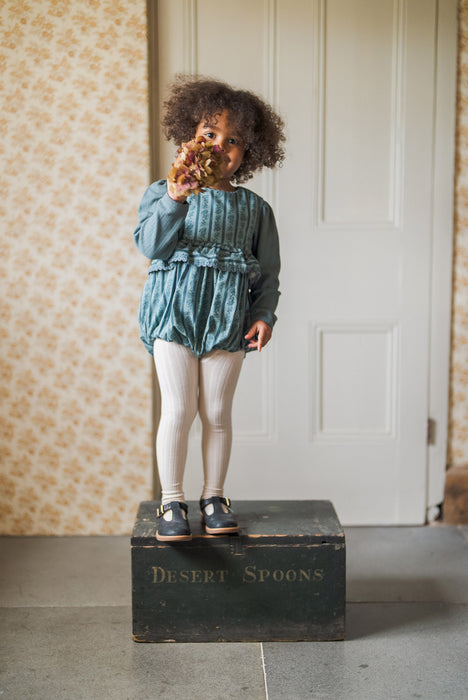 Vintage inspired, teal and Blue floral romper, with frill at the waist finished with gathered trim. Buttons to the back and elastic to the legs. 2