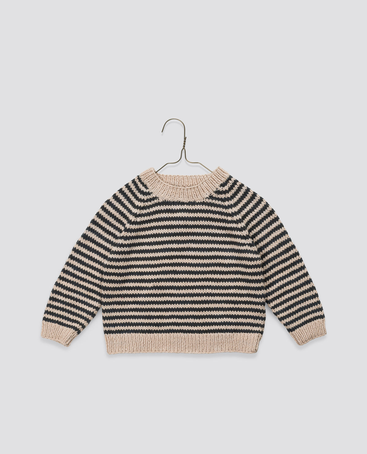 Hand-knitted vintage style children's jumper in black and cream stripe, crafted with organic cotton for sustainable kid's wardrobe.