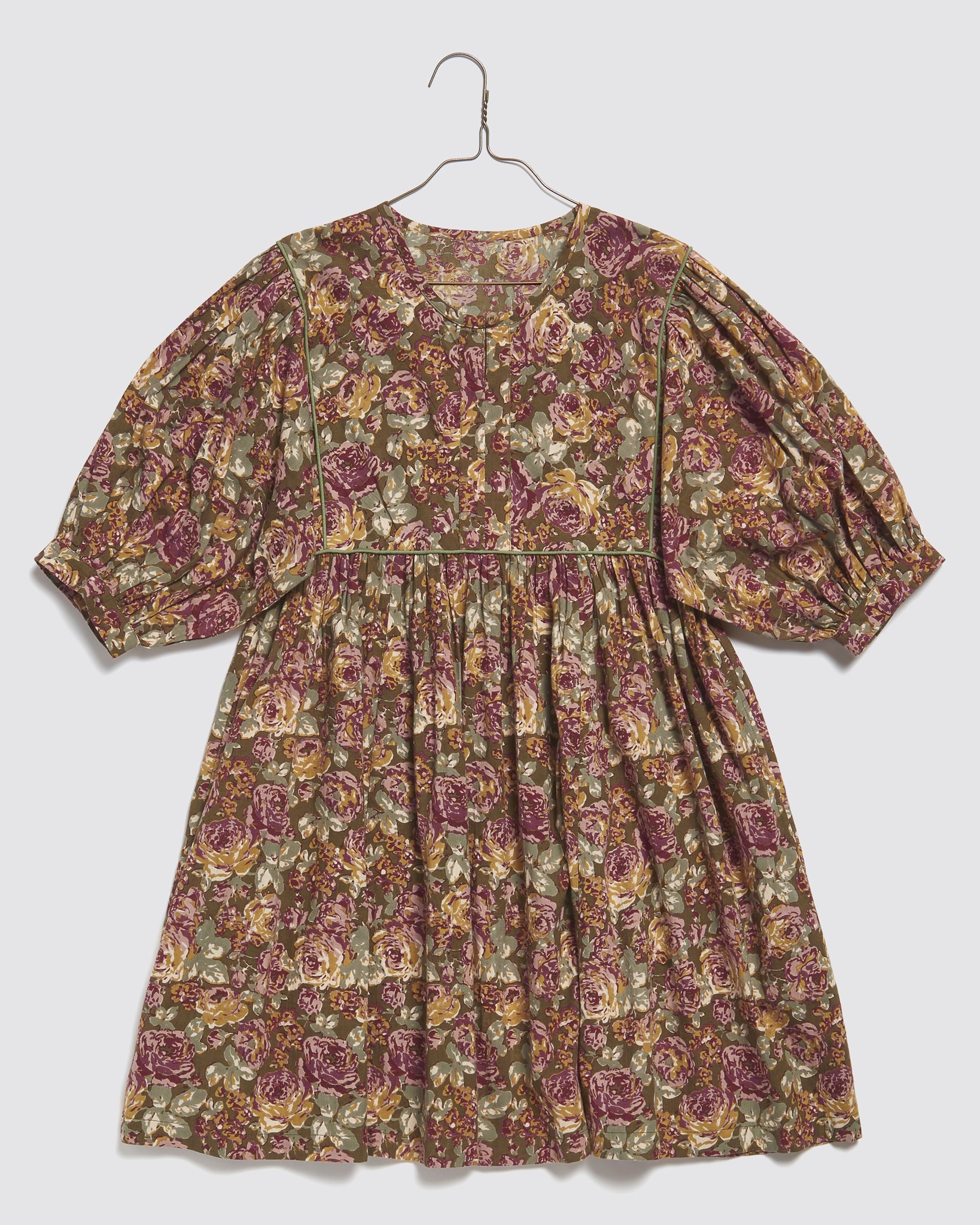 Girls vintage-style dress in floral green organic cotton with puff sleeves, designed ethically with a slow, natural, and sustainable focus.