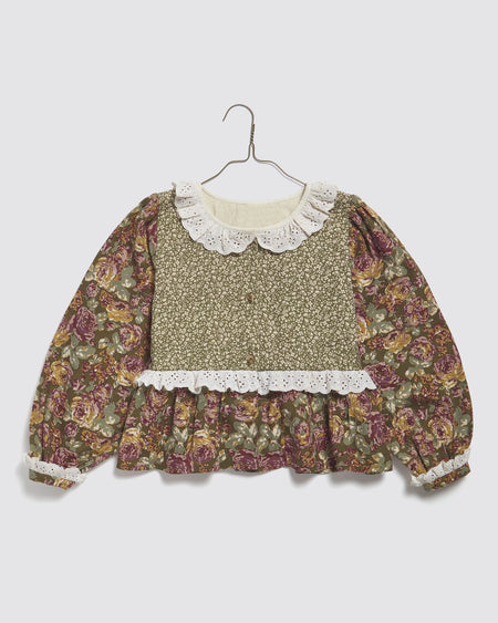 Green floral organic cotton girls blouse with full sleeves a gathered peplum and a gathered cotton trim collar. Made in 100% organic cotton sustainably and ethically. 