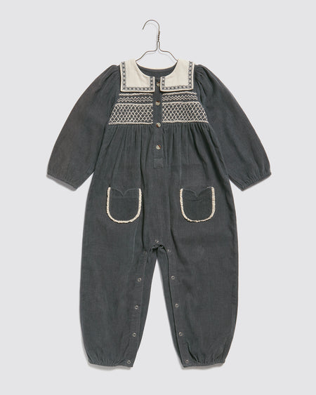 A full length baby children's romper made in our beautiful, organic cotton velvet. White sailor collar with embroidered motif and beautiful hand-smocking.