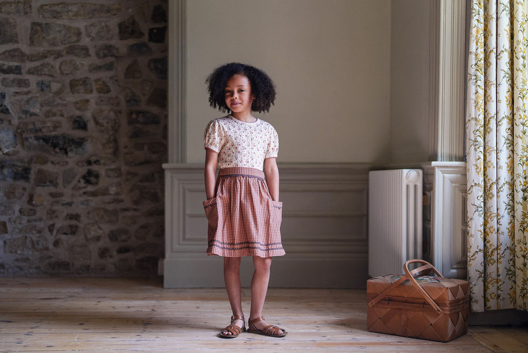 Pointelle jersey, floral t-shirt with pretty pink floral print, worn with tea rose check Margot skirt with pockets and ric-rac trim. 
