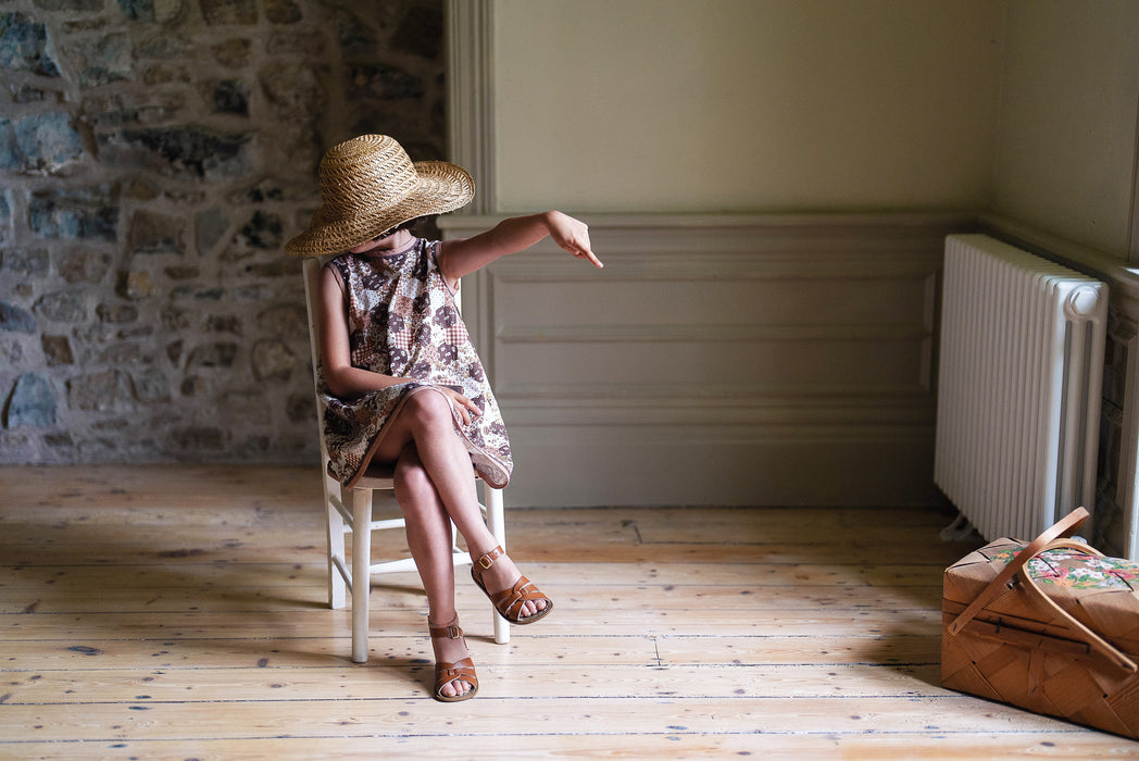 A vintage inspired patchwork print dress, accessorised for summer. Patch pockets with ric-rac trim. 