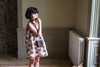 Retro inspired girl's summer dress. Sleeveless design with contrasting trim and patch pockets. Made from printed floral patchwork on organic cotton.