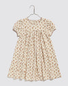 Organic cotton Maya dress in pale pink, Bronte floral print pointelle, jersey fabric. short puff sleeves with contrasting stitch to the binding. A sample and comfortable jersey play dress.