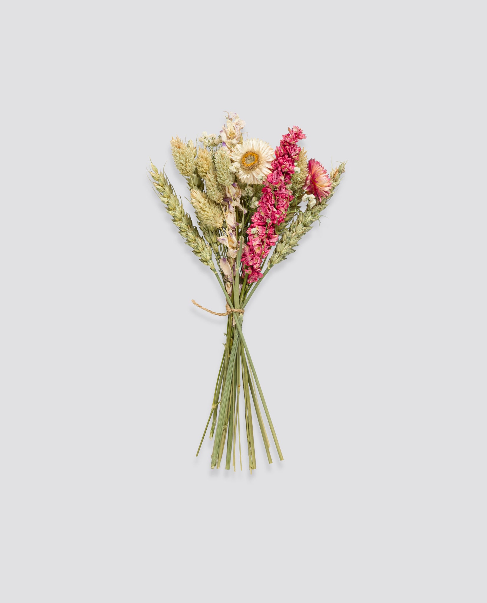 A delicate bunch of locally grown dried wildflowers in pinks, whites, and yellows, reflecting a natural, organic, and vintage-inspired aesthetic.