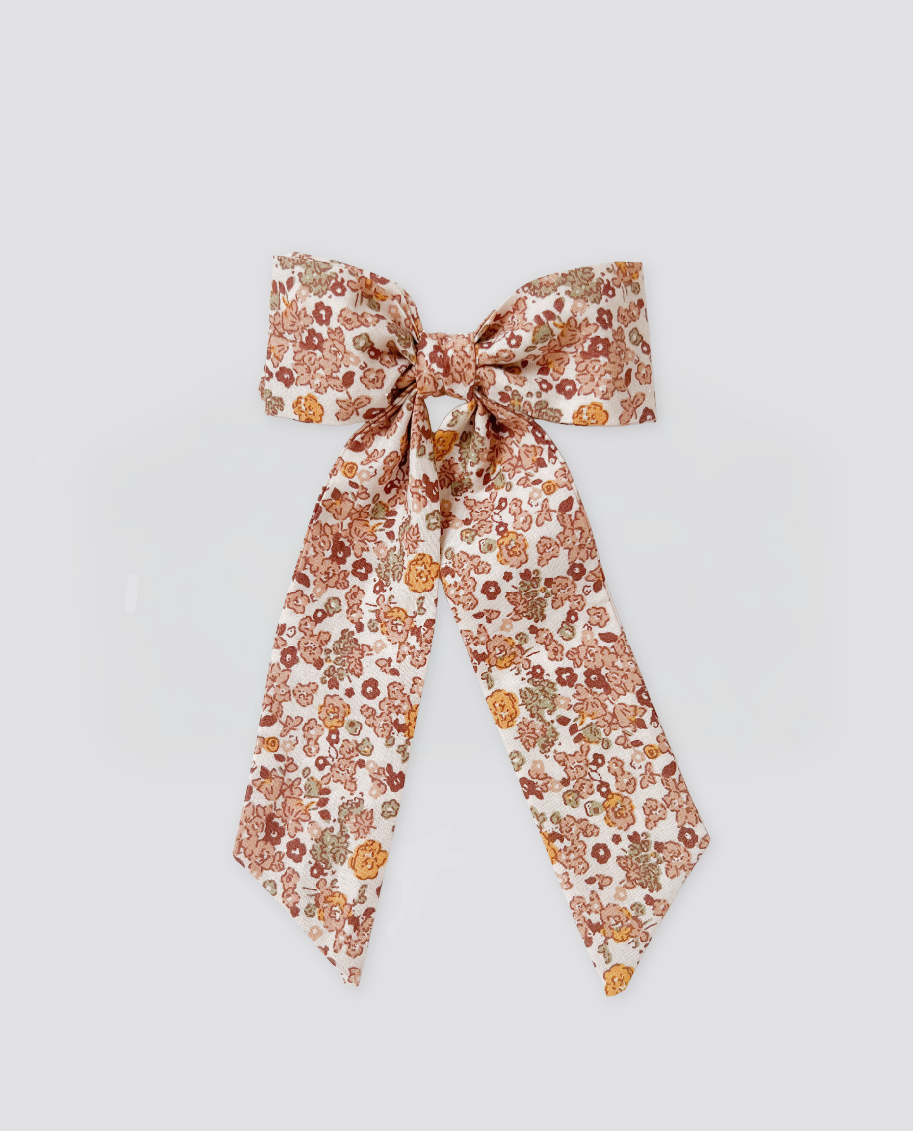 Vintage style floral bow clip in soft natural tones, made from organic cotton for a sustainable and safe accessory perfect for children's clothing.