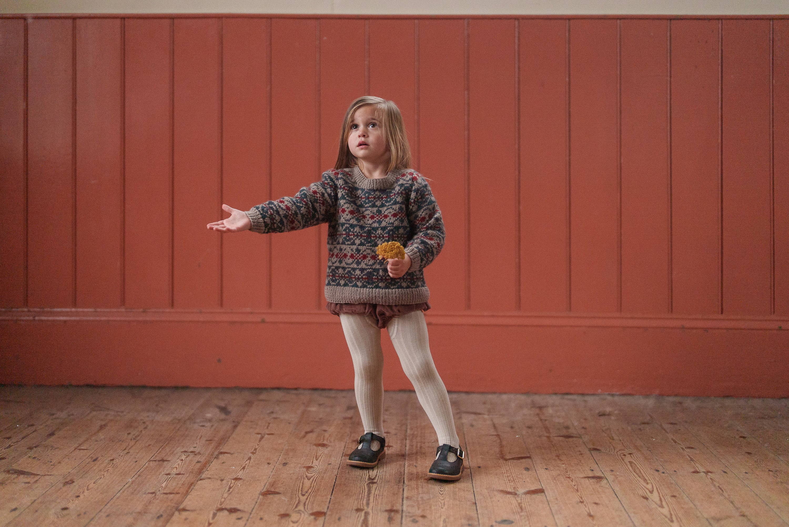 Toddler wearing vintage style children's clothing in natural shades, featuring organic cotton with sustainable, ethically made materials in a cozy, classic look.