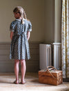 Our timeless, vintage inspired Orla Dress has been made in our organic cotton thistle floral fabric. This pretty children's dress is perfect for special occasions or everyday wear. It has beautiful hand smocking over a gathered bodice, full, puffed sleeves with contrasting cuffs and a contrasting Peter Pan collar. Designed for comfort and style, the full skirt allows for easy movement and the tie up back gives a lovely silhouette. 
