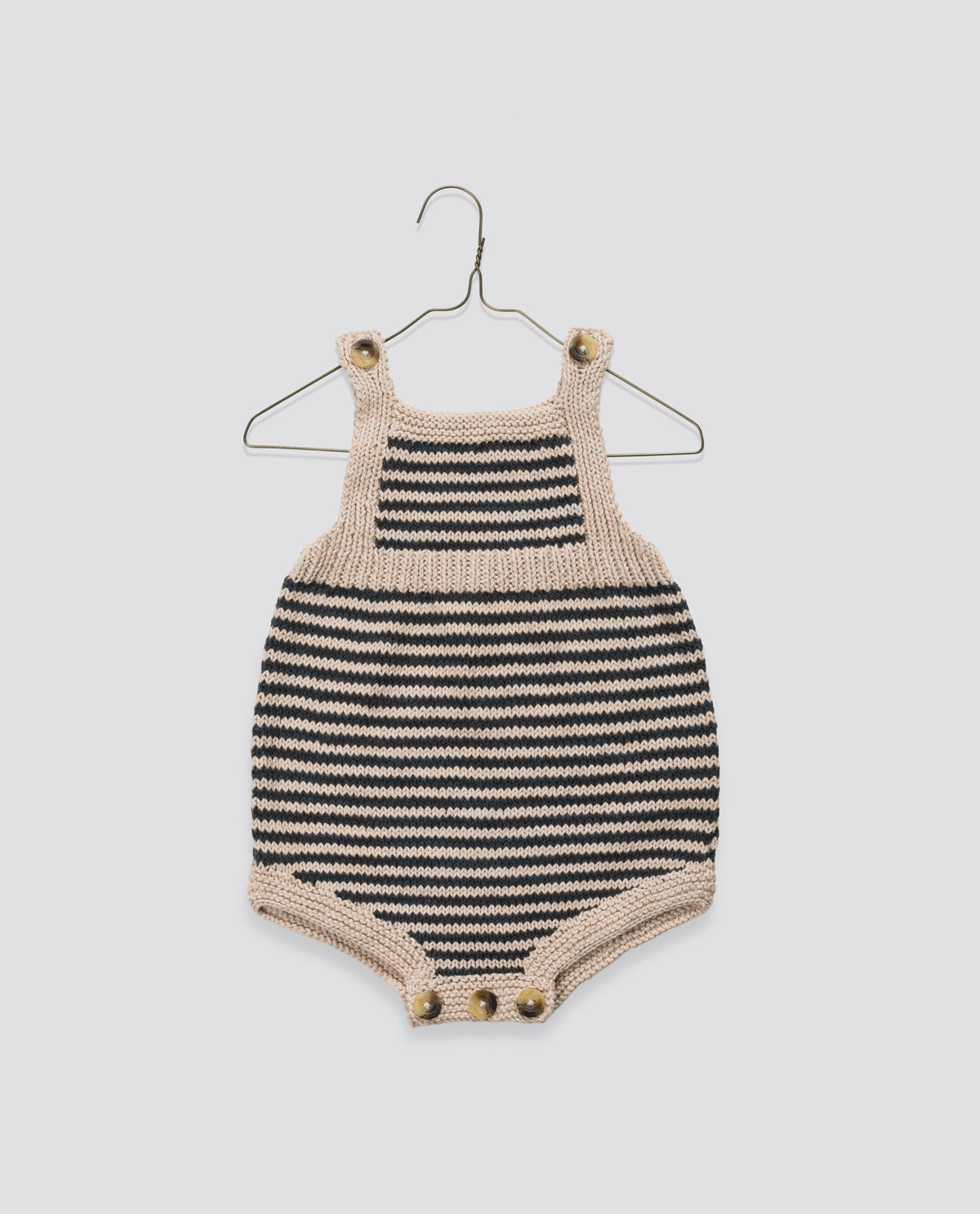 Vintage inspired black and beige hand knitted romper, crafted sustainably.