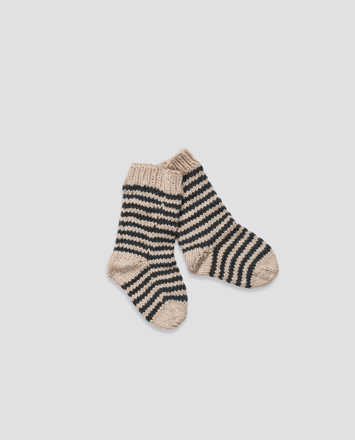 Hand-knitted cosy striped socks made with soft wool, ethically made for sustainable children's living.